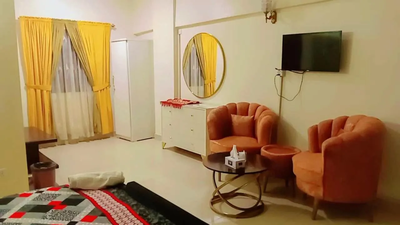 Communal lounge/ TV room, Bed in Hotel 7 DHA
