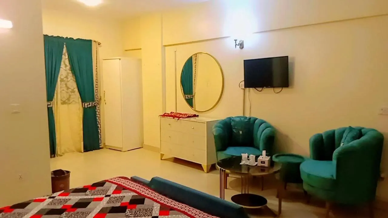 Communal lounge/ TV room, Bed in Hotel 7 DHA