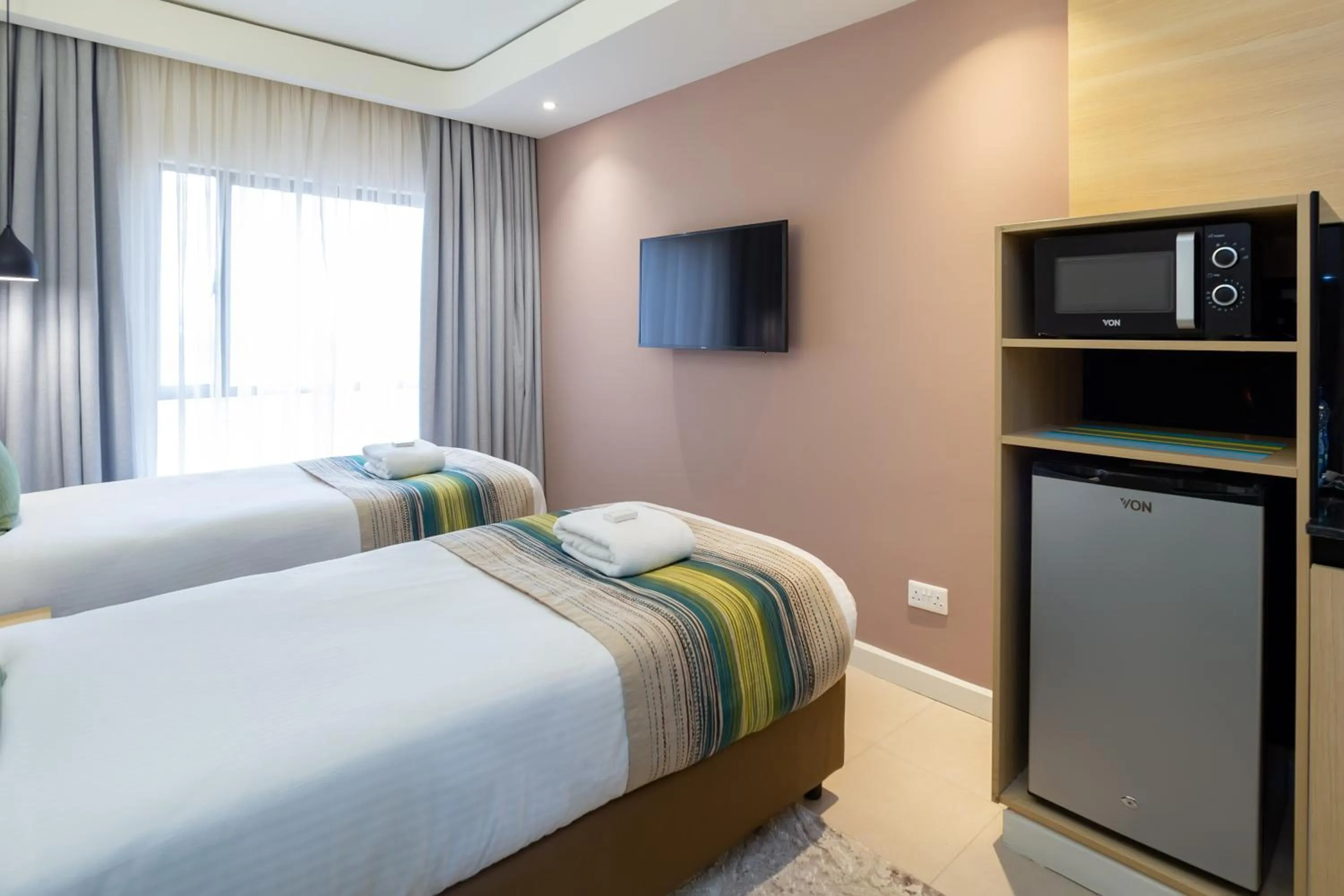 Photo of the whole room, Bed in Kozi Suites Nairobi Airport