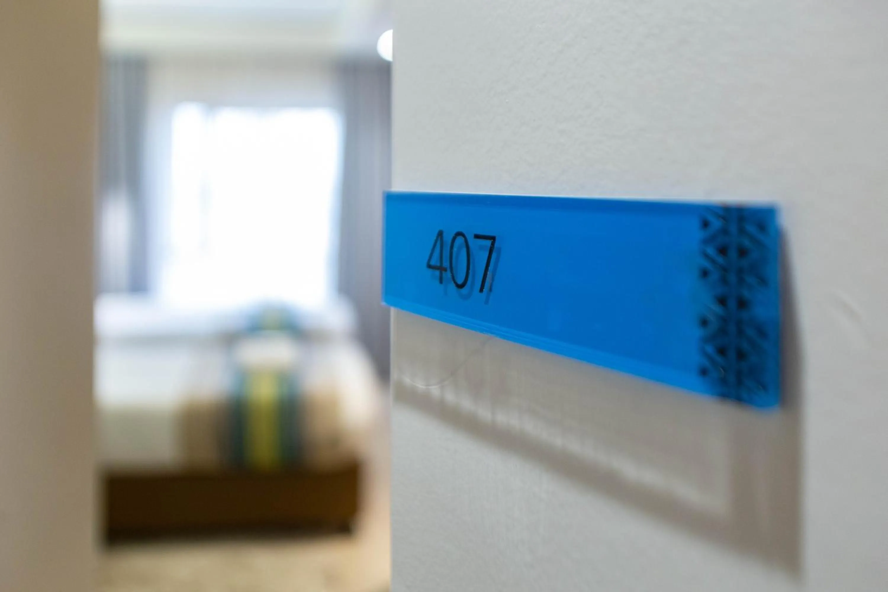 Property logo or sign, Bed in Kozi Suites Nairobi Airport