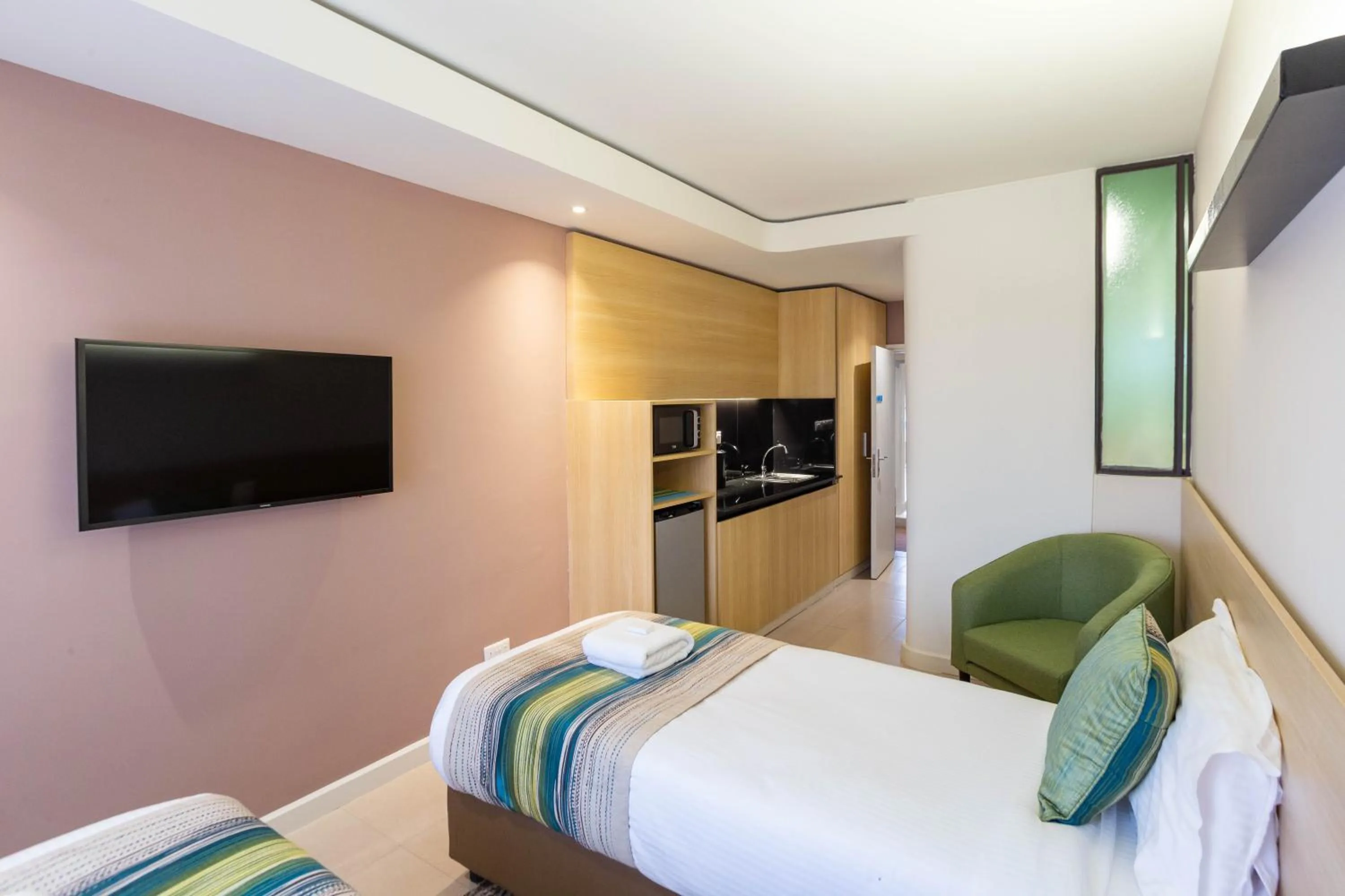 TV and multimedia, Bed in Kozi Suites Nairobi Airport