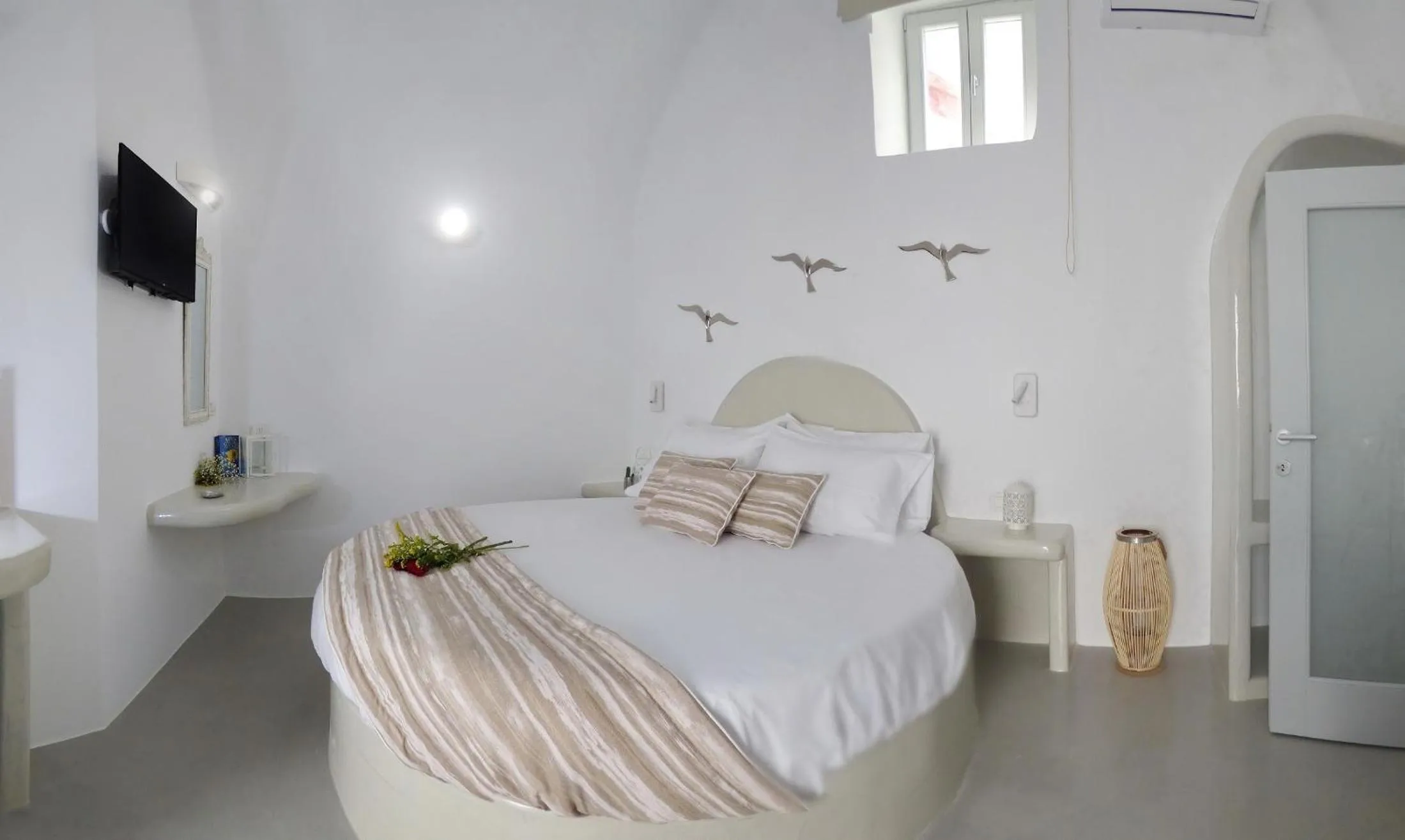 Bed in Golden Stone Santorini Suites