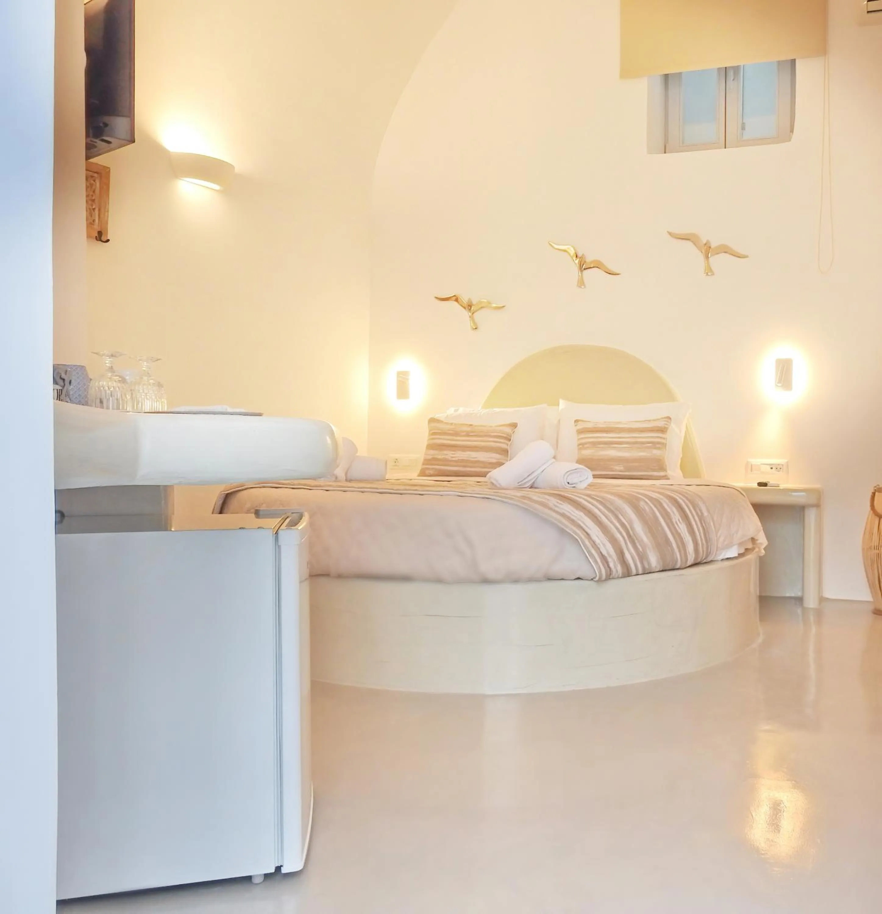 Bed in Golden Stone Santorini Suites