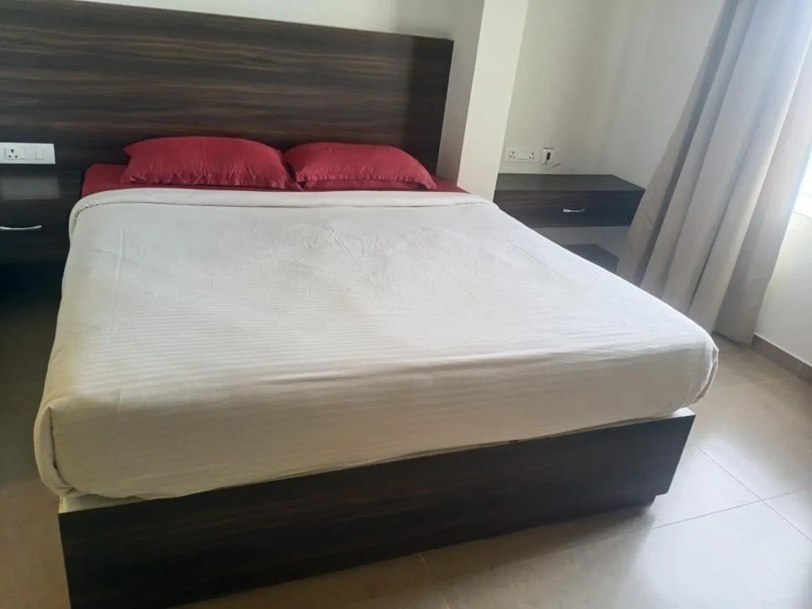 Bed in AARYA MANSION V One Hotel