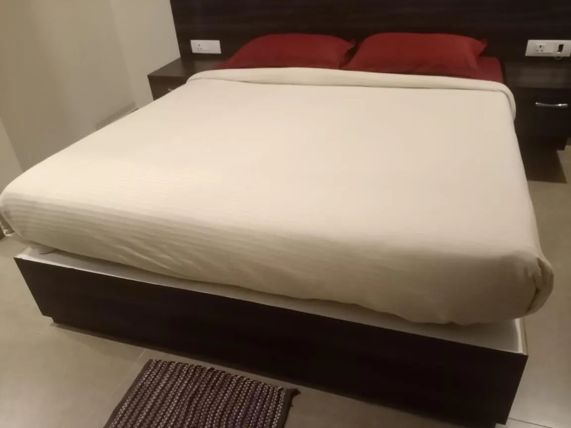 Bed in AARYA MANSION V One Hotel