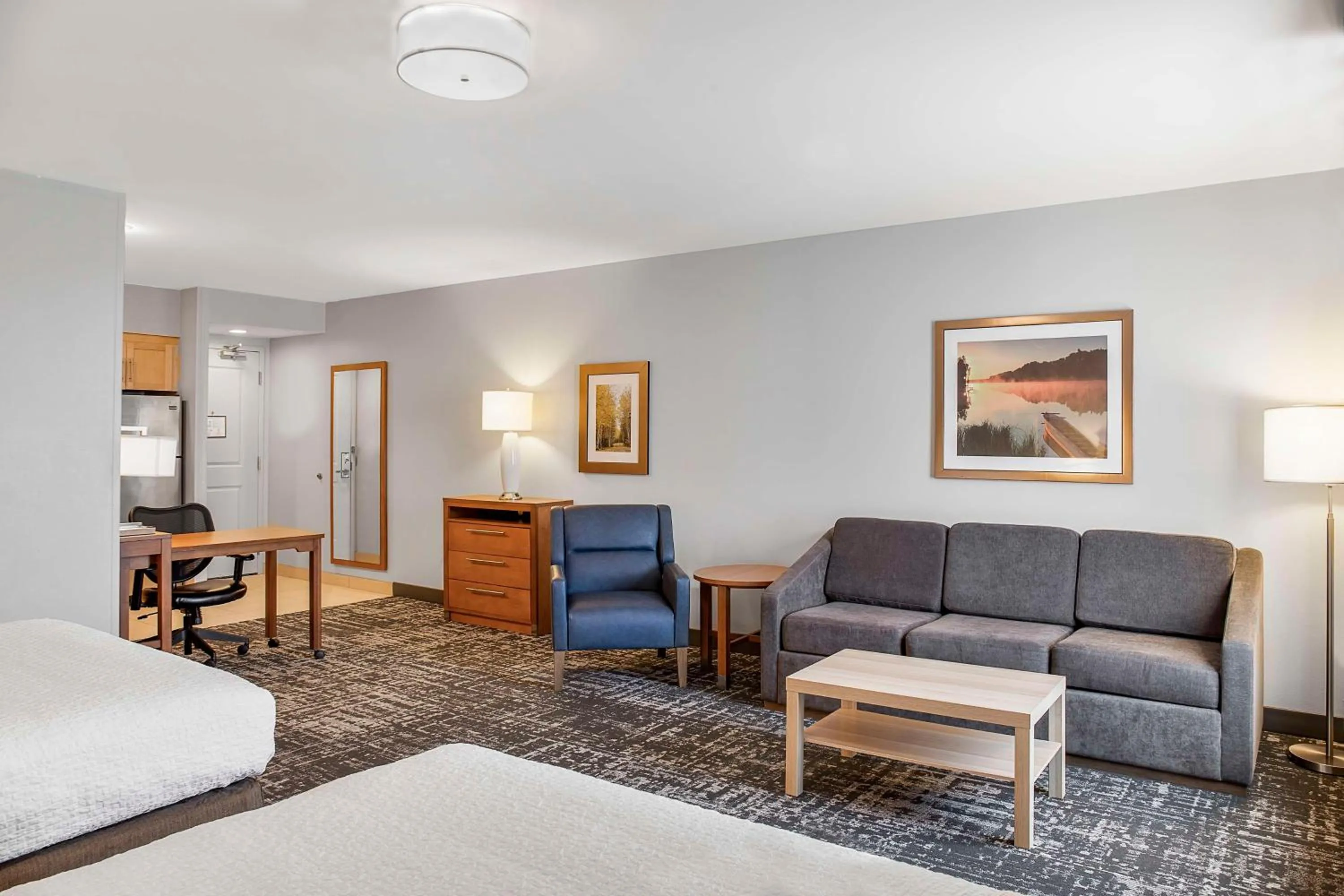 Living room, Bed in Homewood Suites by Hilton Winnipeg Airport - Polo Park
