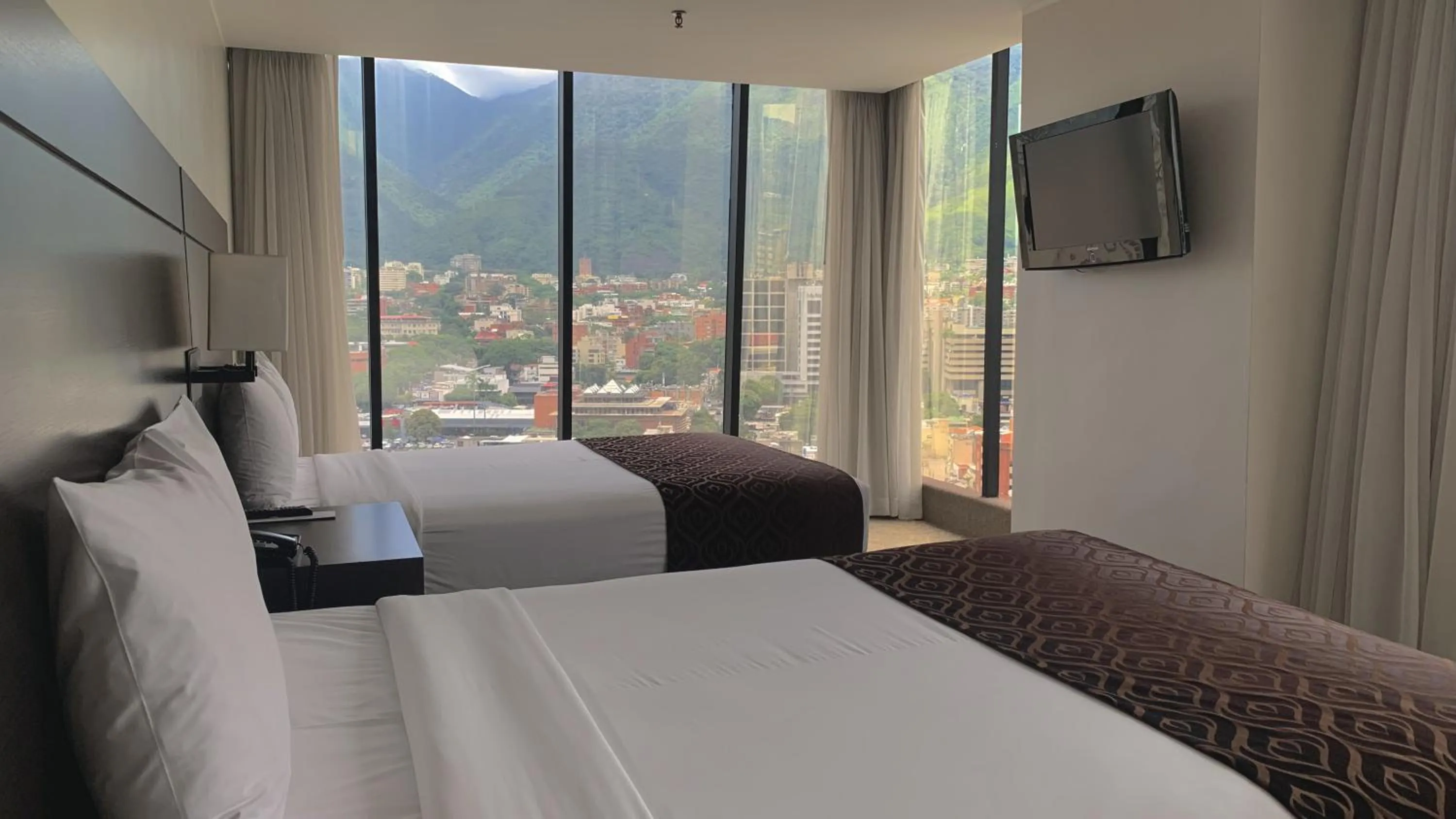 View (from property/room), Bed in HOTEL CHACAO SUITES