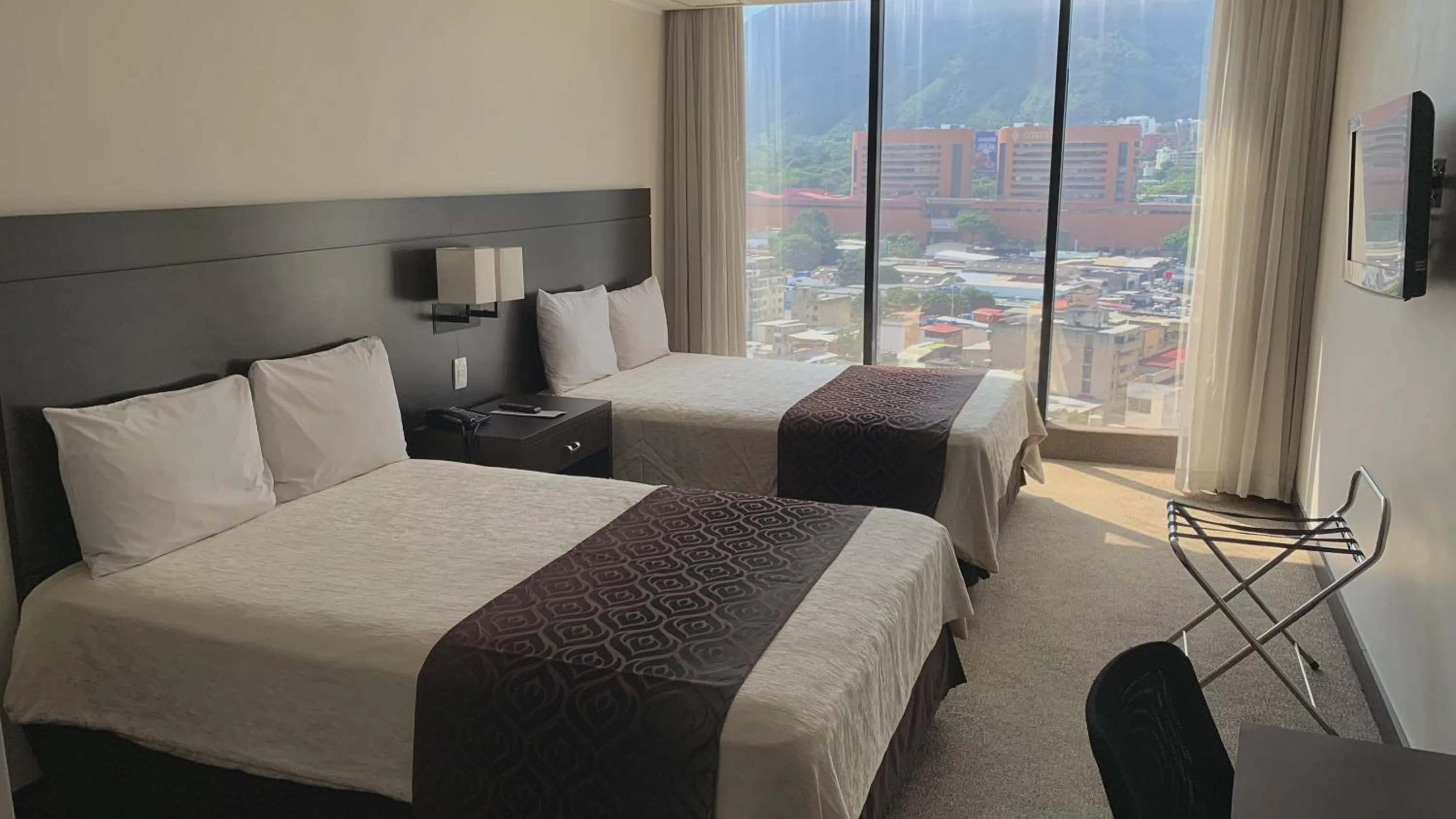 Bed in HOTEL CHACAO SUITES