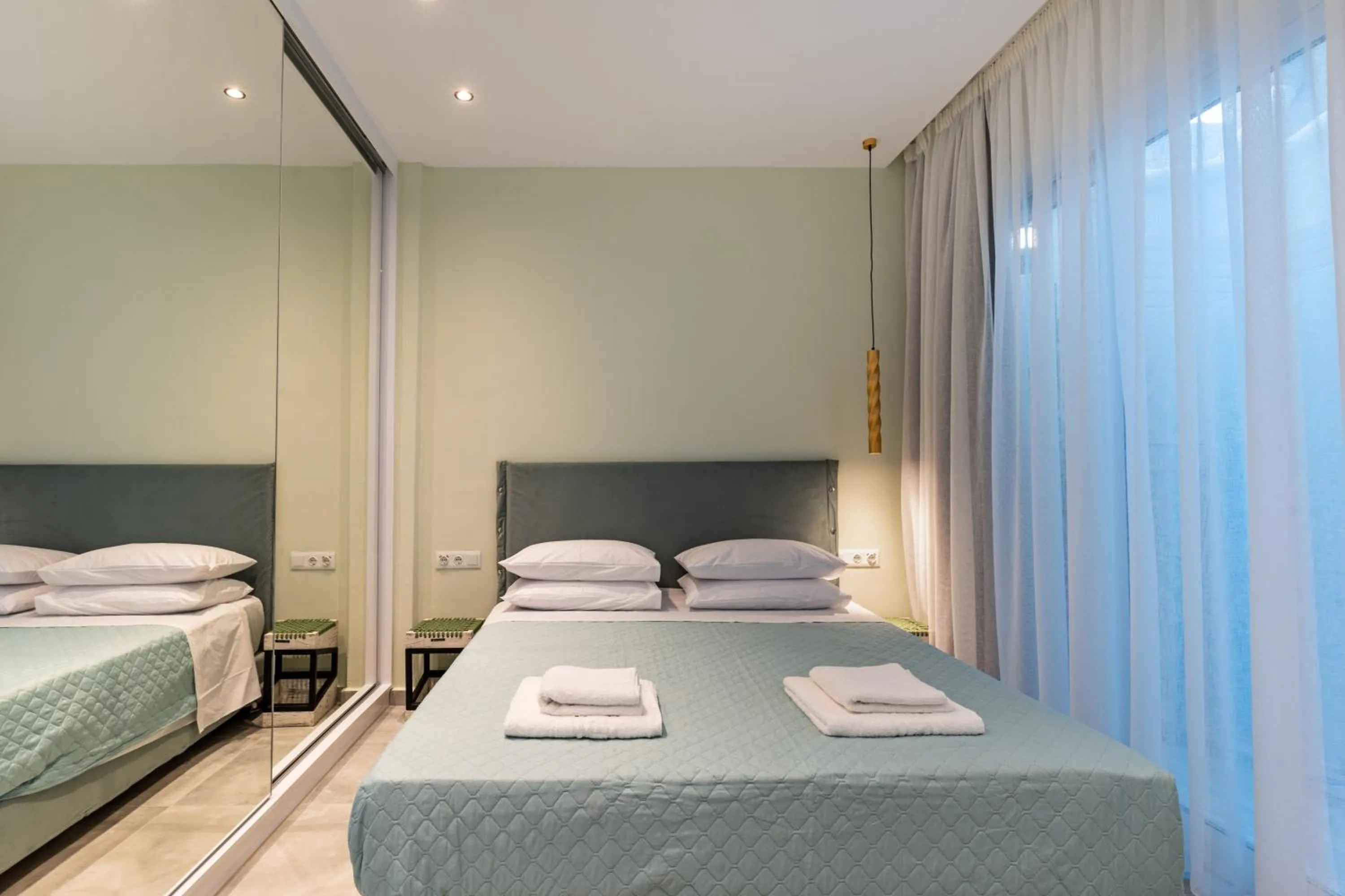 Bed in City and Sand Suites