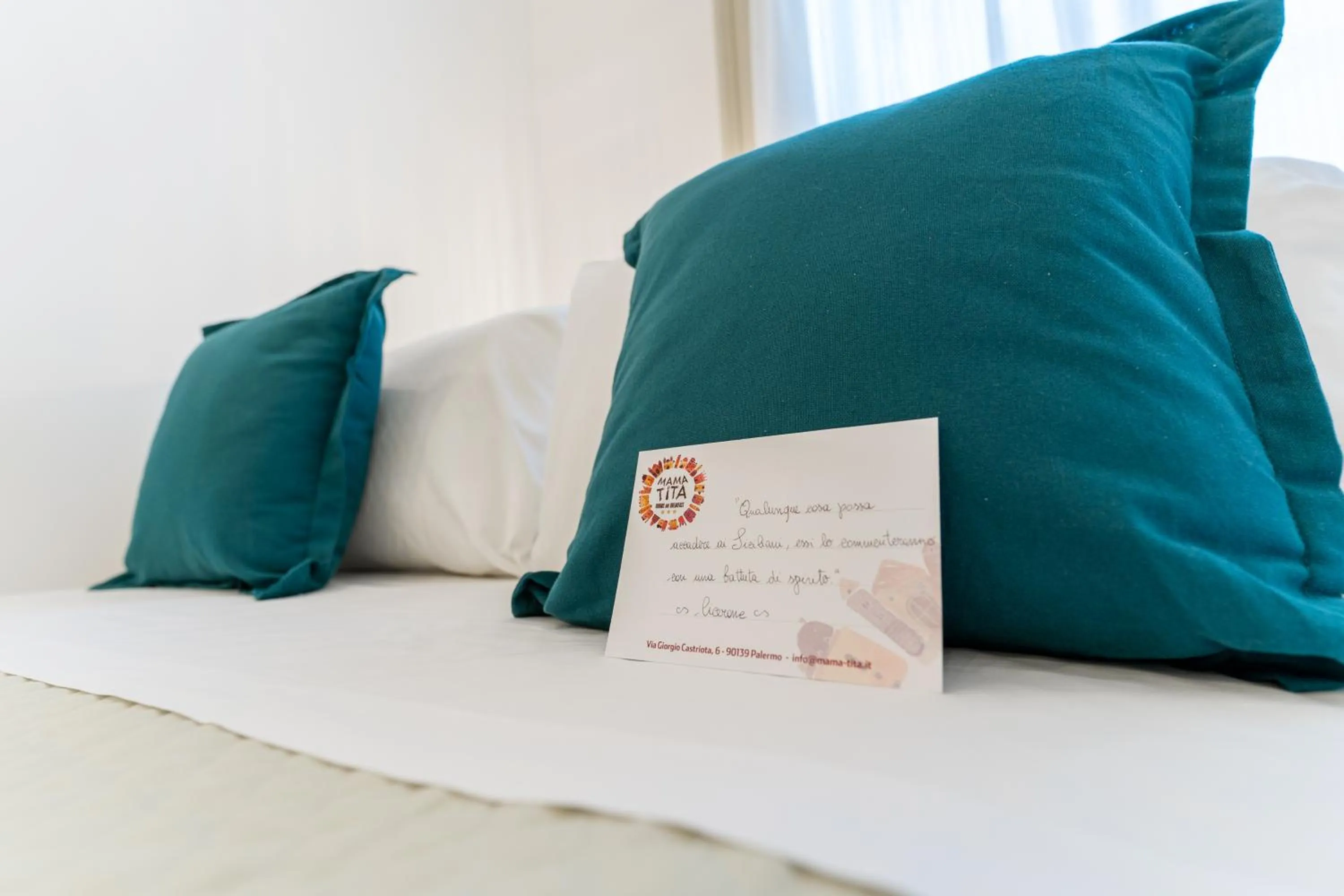 Bed in Mama Tita Rooms and Breakfast