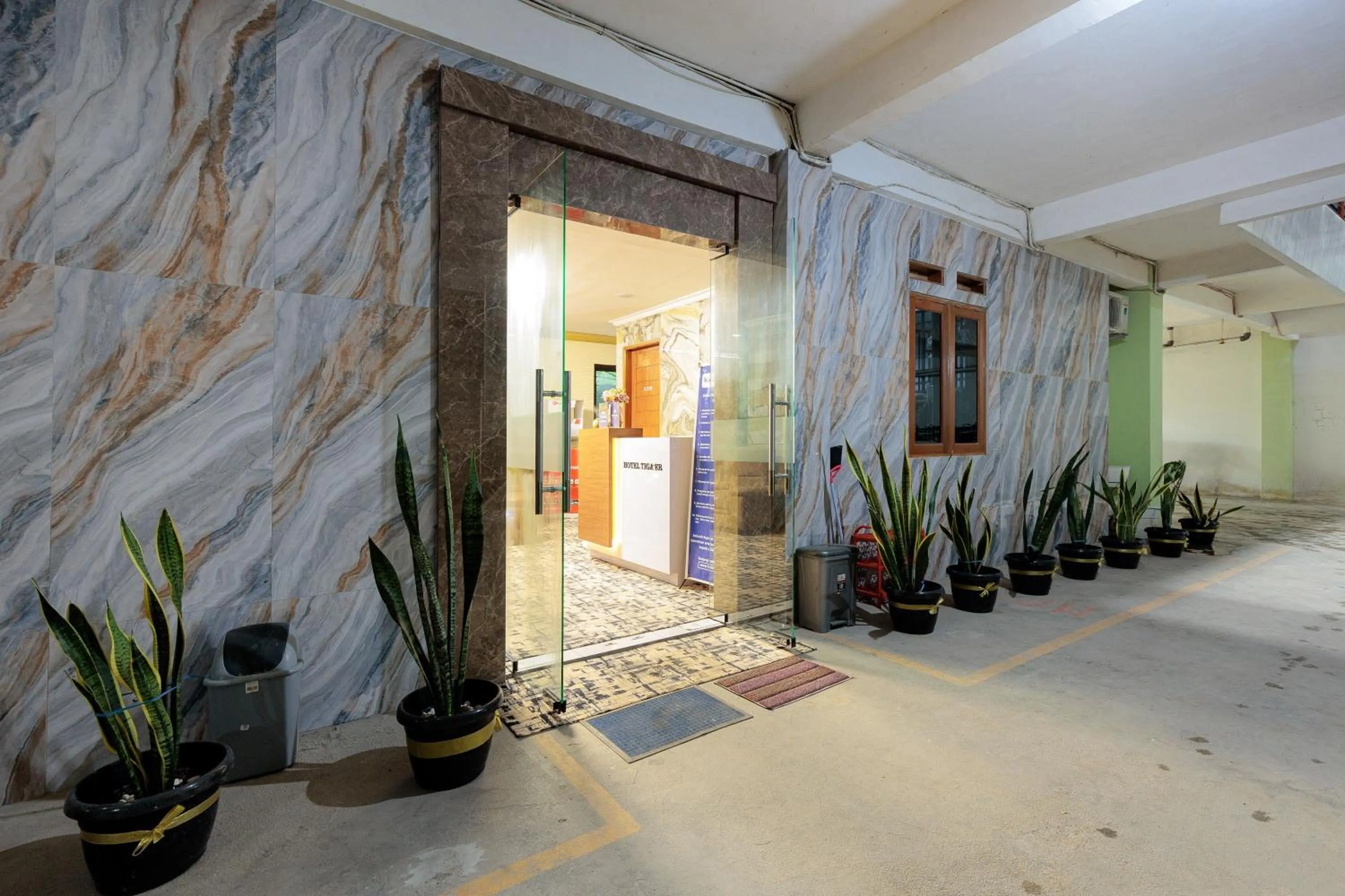 Facade/entrance in RedDoorz Syariah at Hotel Tiga ER near Karawang Central Plaza