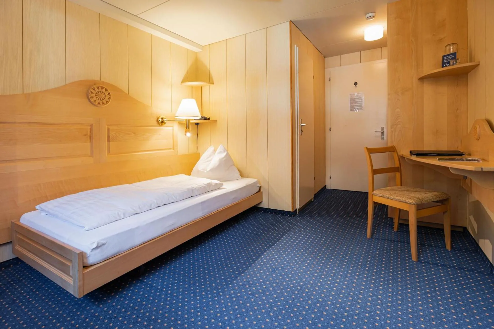 Bed in Hotel Bellevue - Traditional Swiss Hideaway