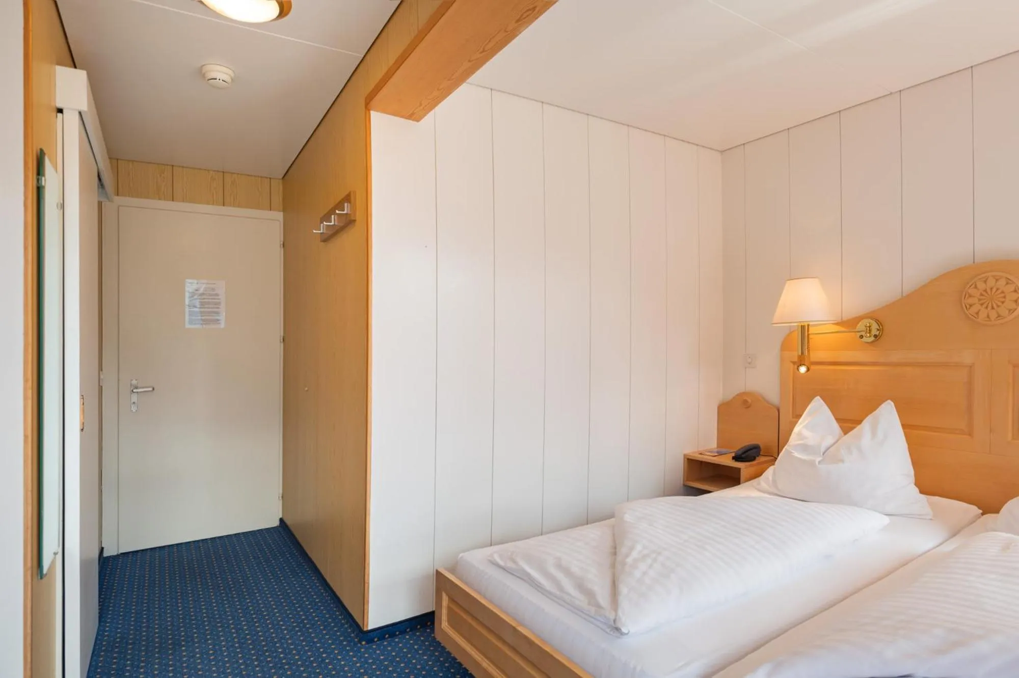 Bed in Hotel Bellevue - Traditional Swiss Hideaway