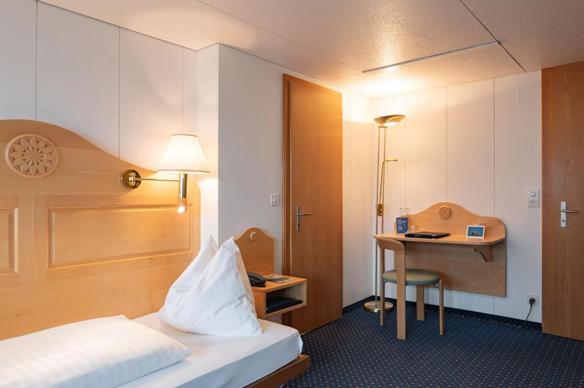 Bed in Hotel Bellevue - Traditional Swiss Hideaway