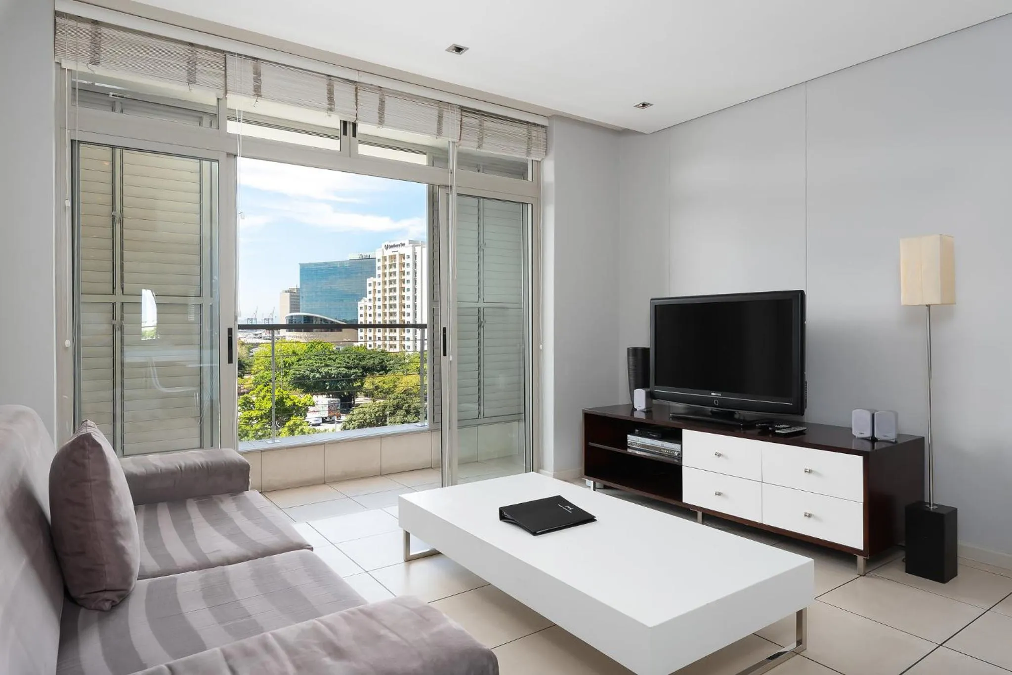 TV and multimedia, Seating Area in HarbourEdge Suites by Totalstay