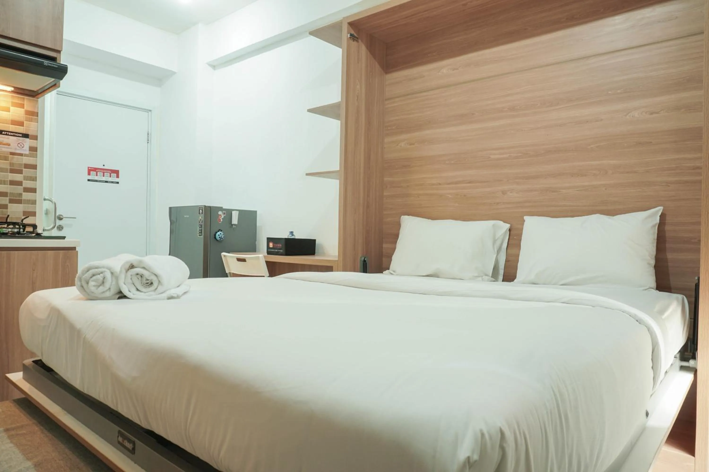 Bed in Lovely and Strategic Studio at Green Pramuka Apartment By Travelio