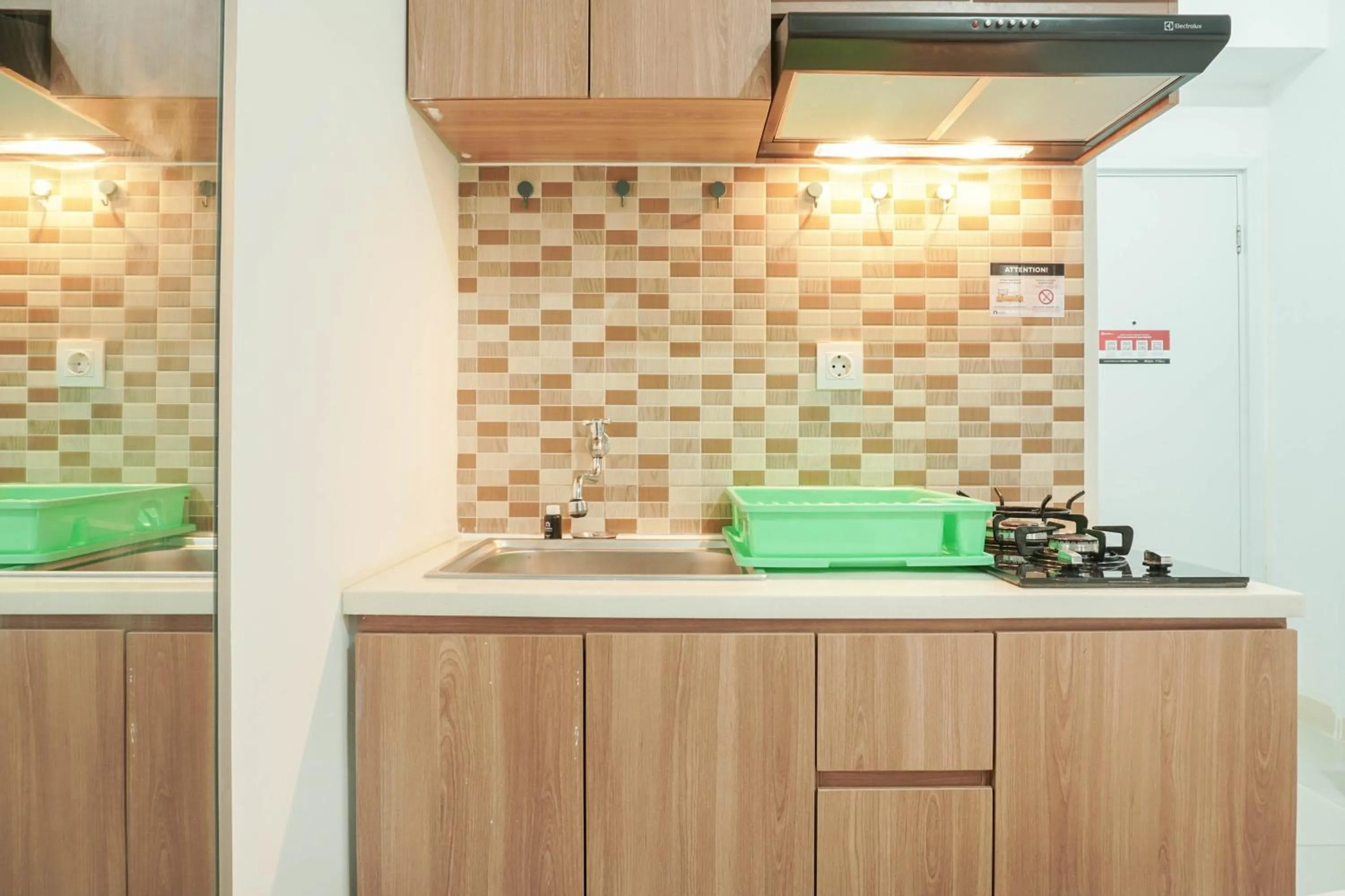 Kitchen or kitchenette in Lovely and Strategic Studio at Green Pramuka Apartment By Travelio