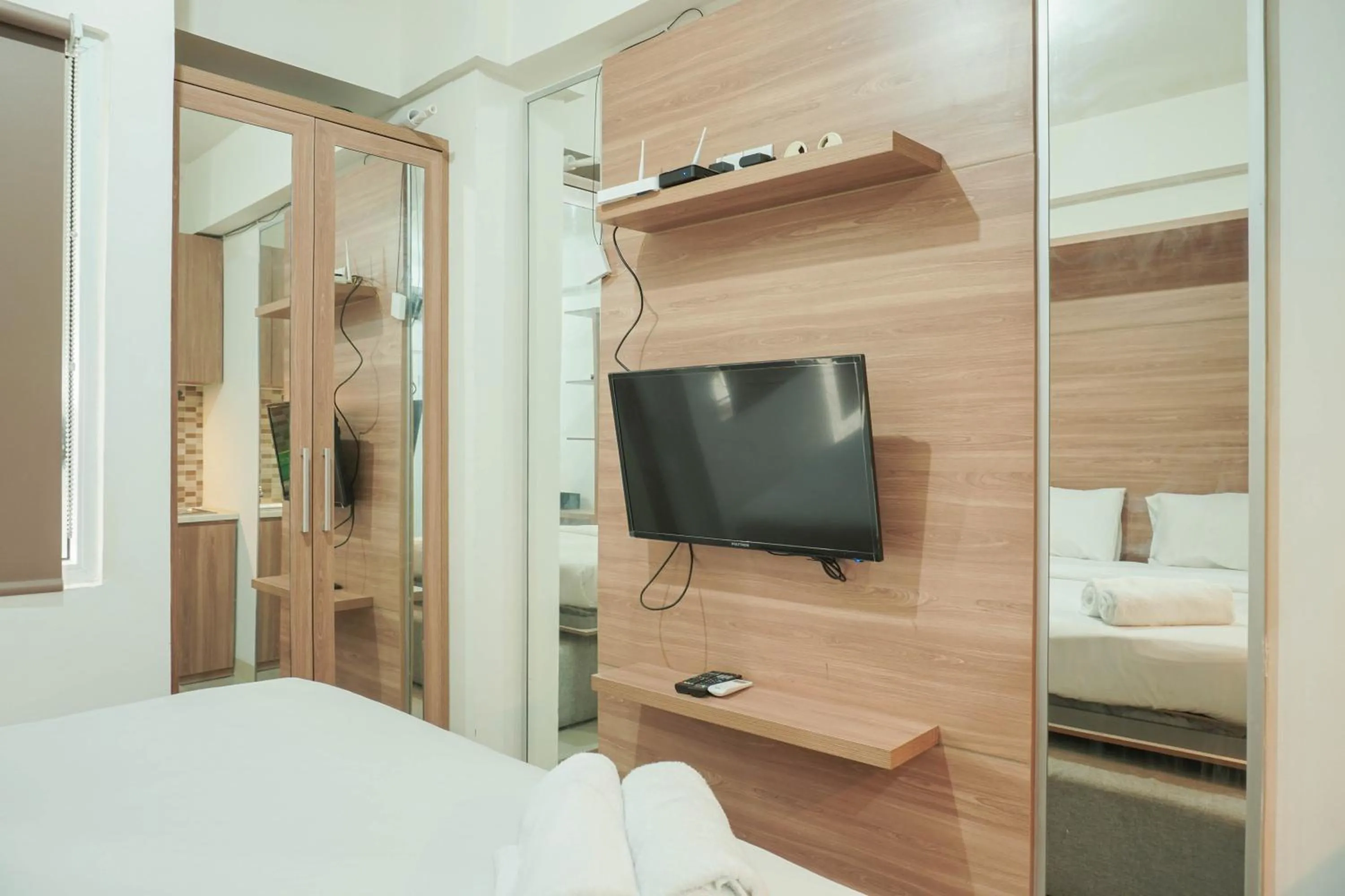 Bed in Lovely and Strategic Studio at Green Pramuka Apartment By Travelio