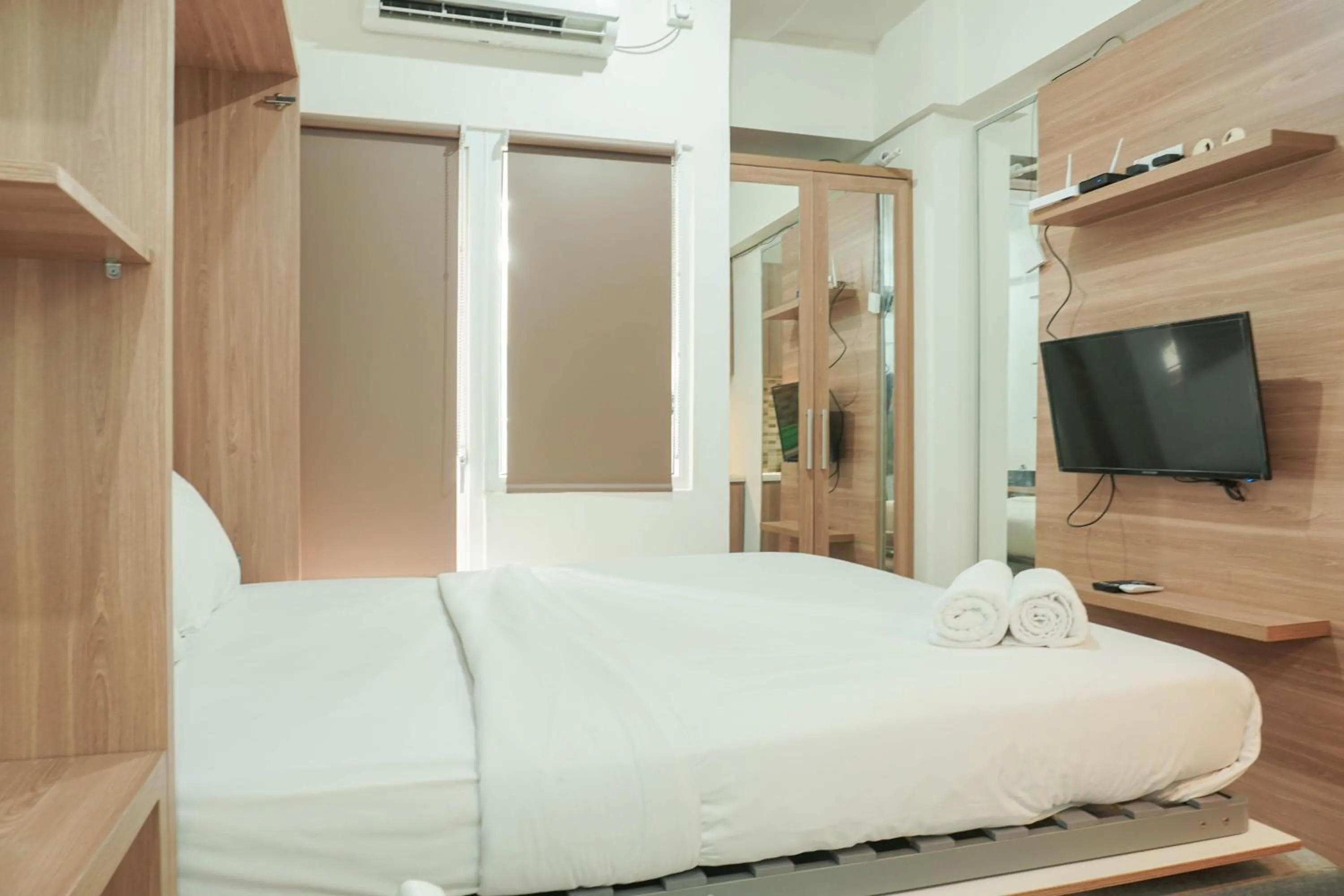 Bed in Lovely and Strategic Studio at Green Pramuka Apartment By Travelio