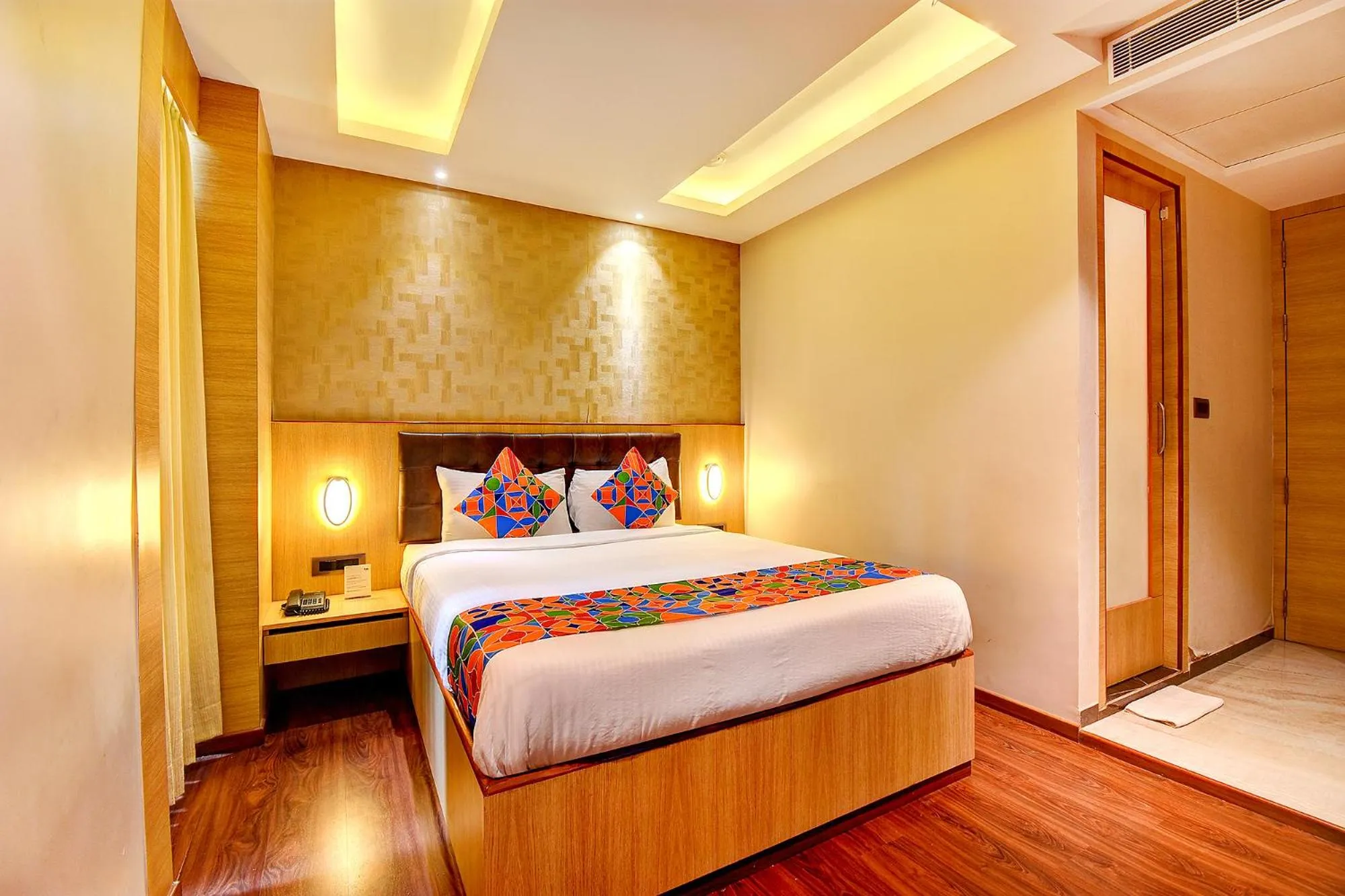 Seating area, Bed in FabHotel S Comfort Inn - Indiranagar