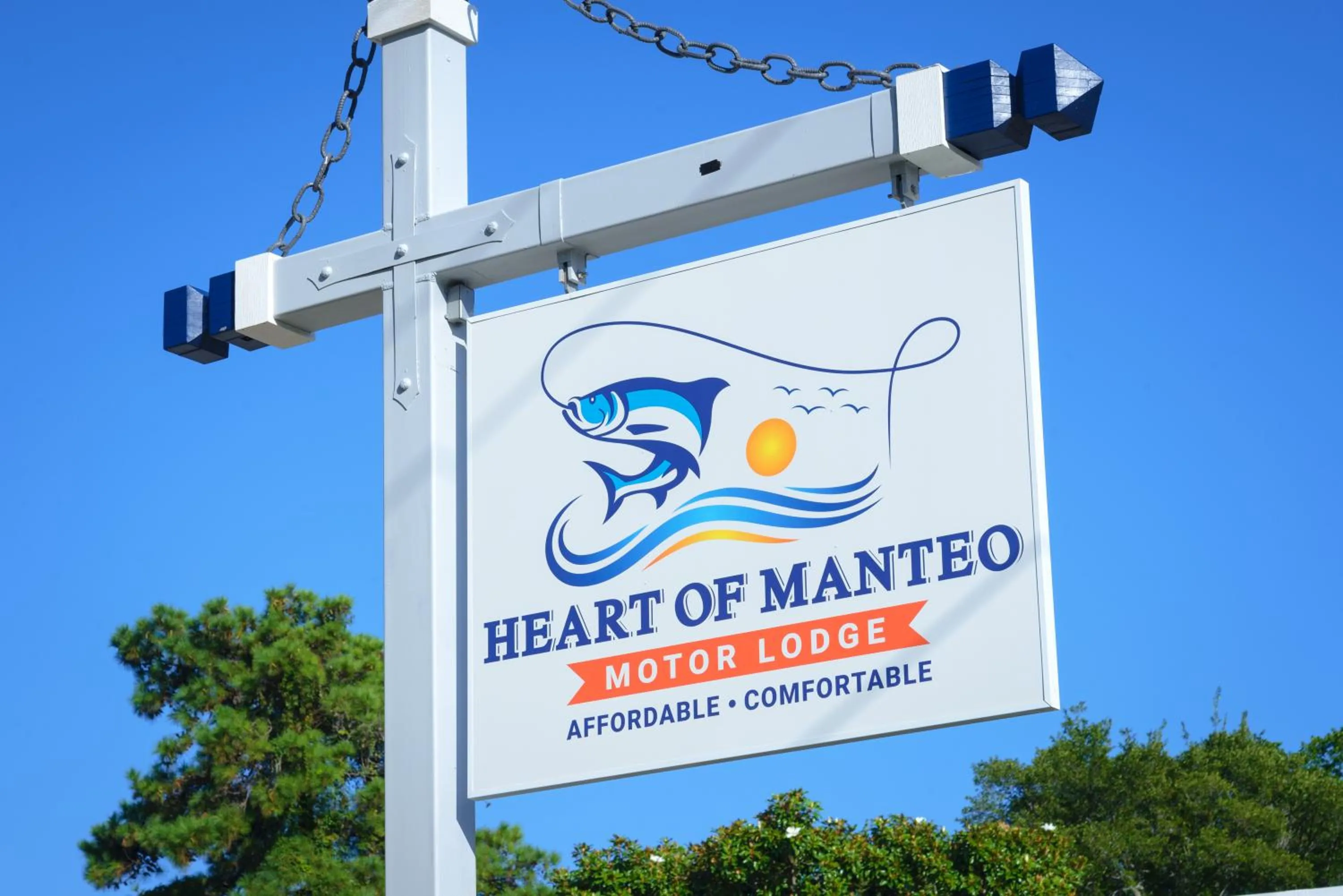 Property logo or sign in Heart of Manteo