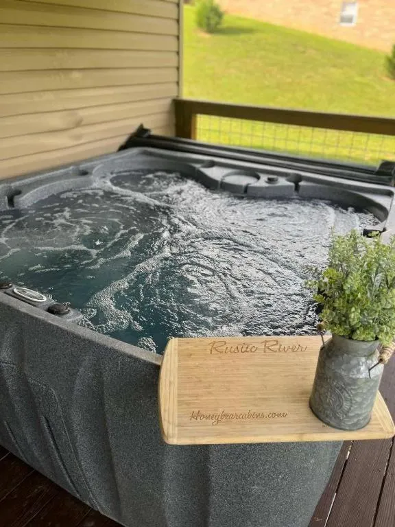Hot Tub in Rustic River Lodge by HoneyBearCabins 7BR 6BA sleeps 21