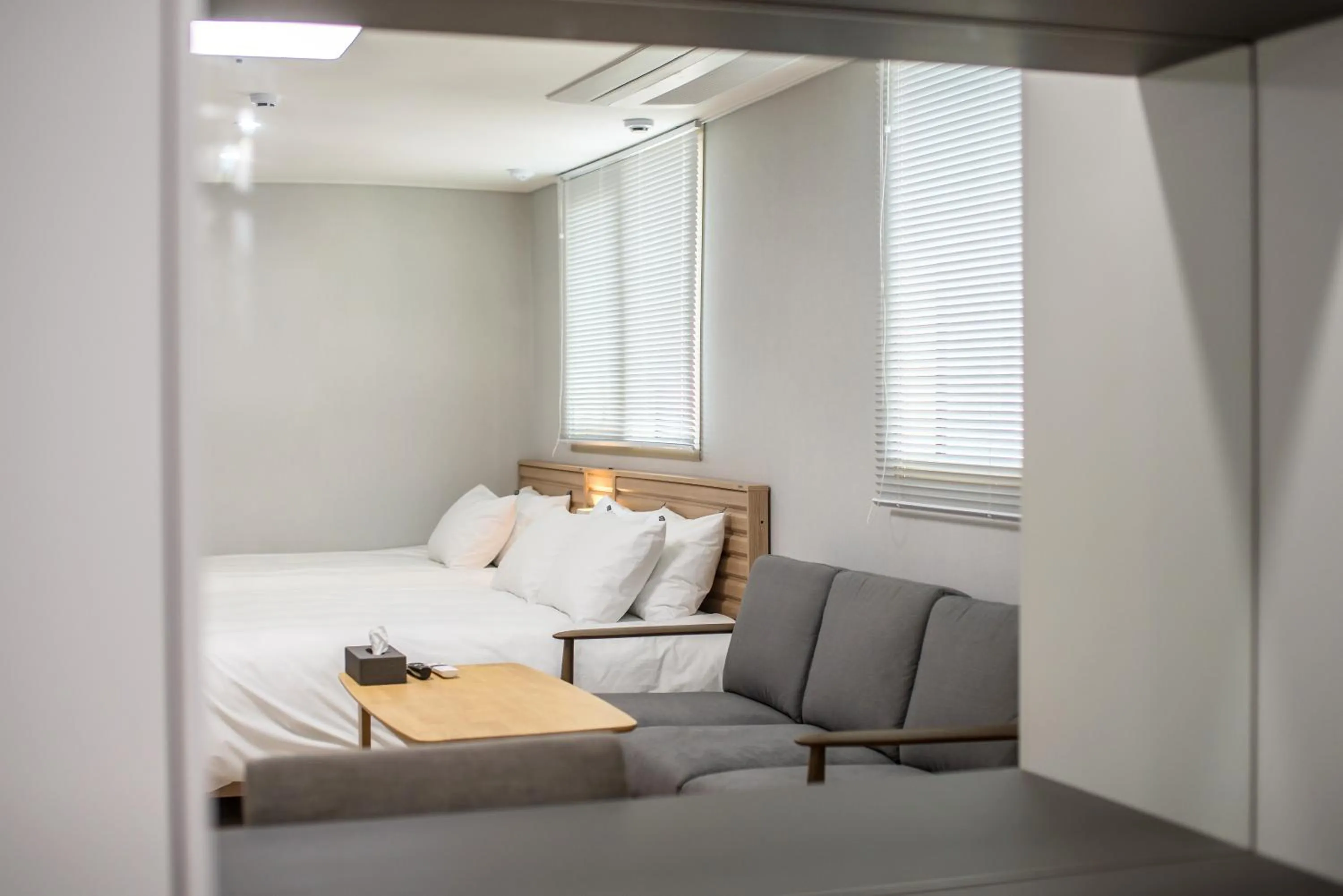 Seating area, Bed in Jeju Central Park Residence