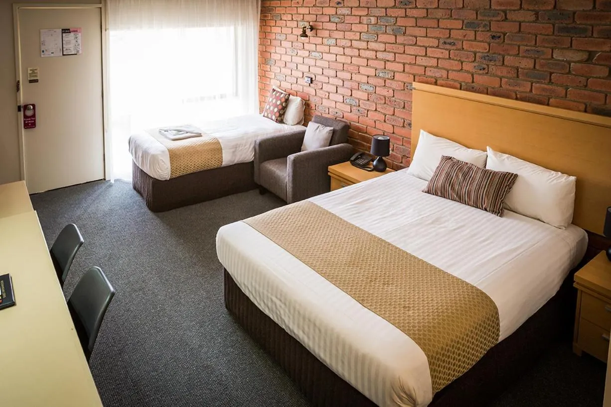 Bed in Australian Settlers Motor Inn