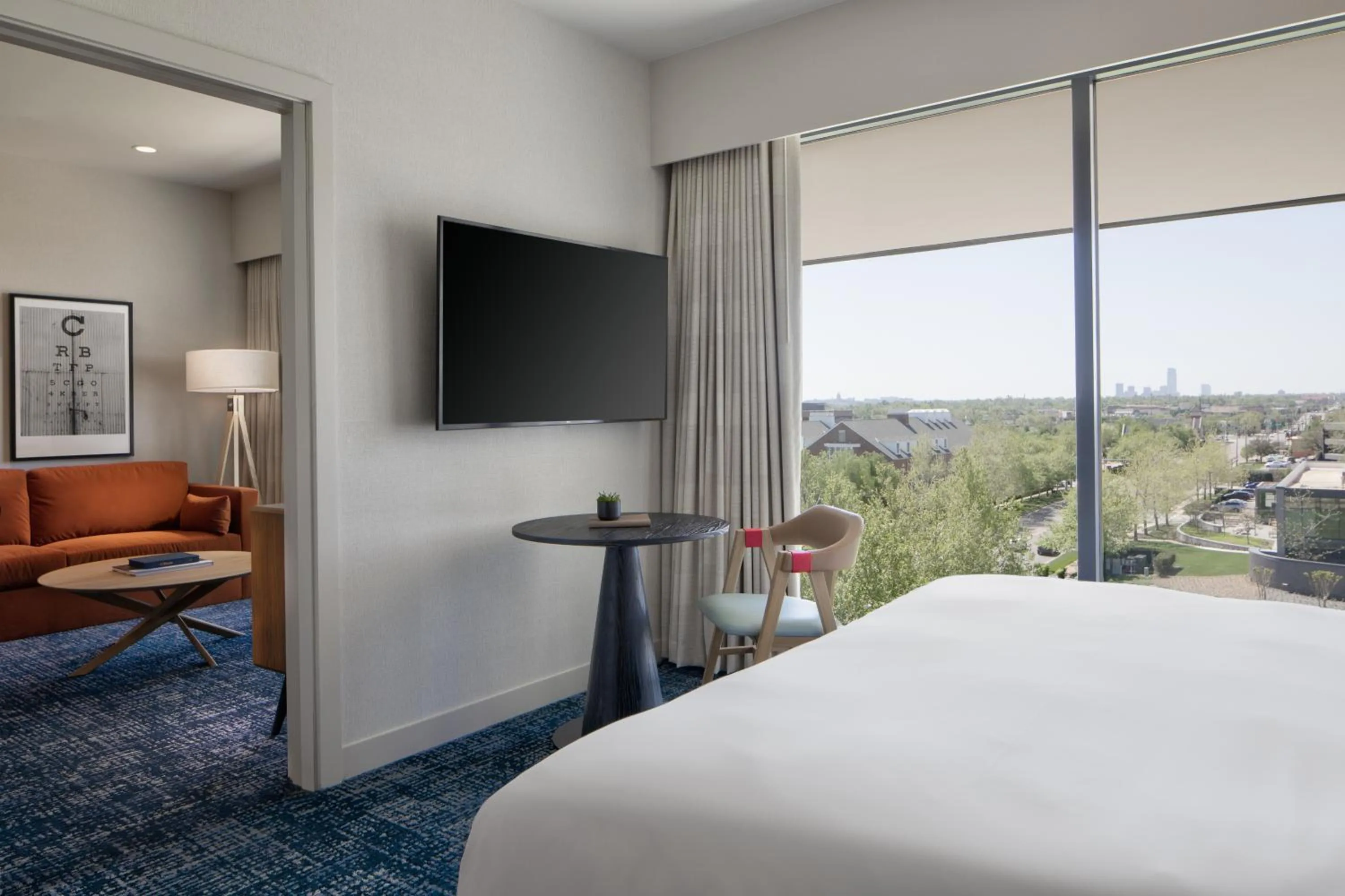 Living room, Bed in The Ellison, Oklahoma City, a Tribute Portfolio Hotel