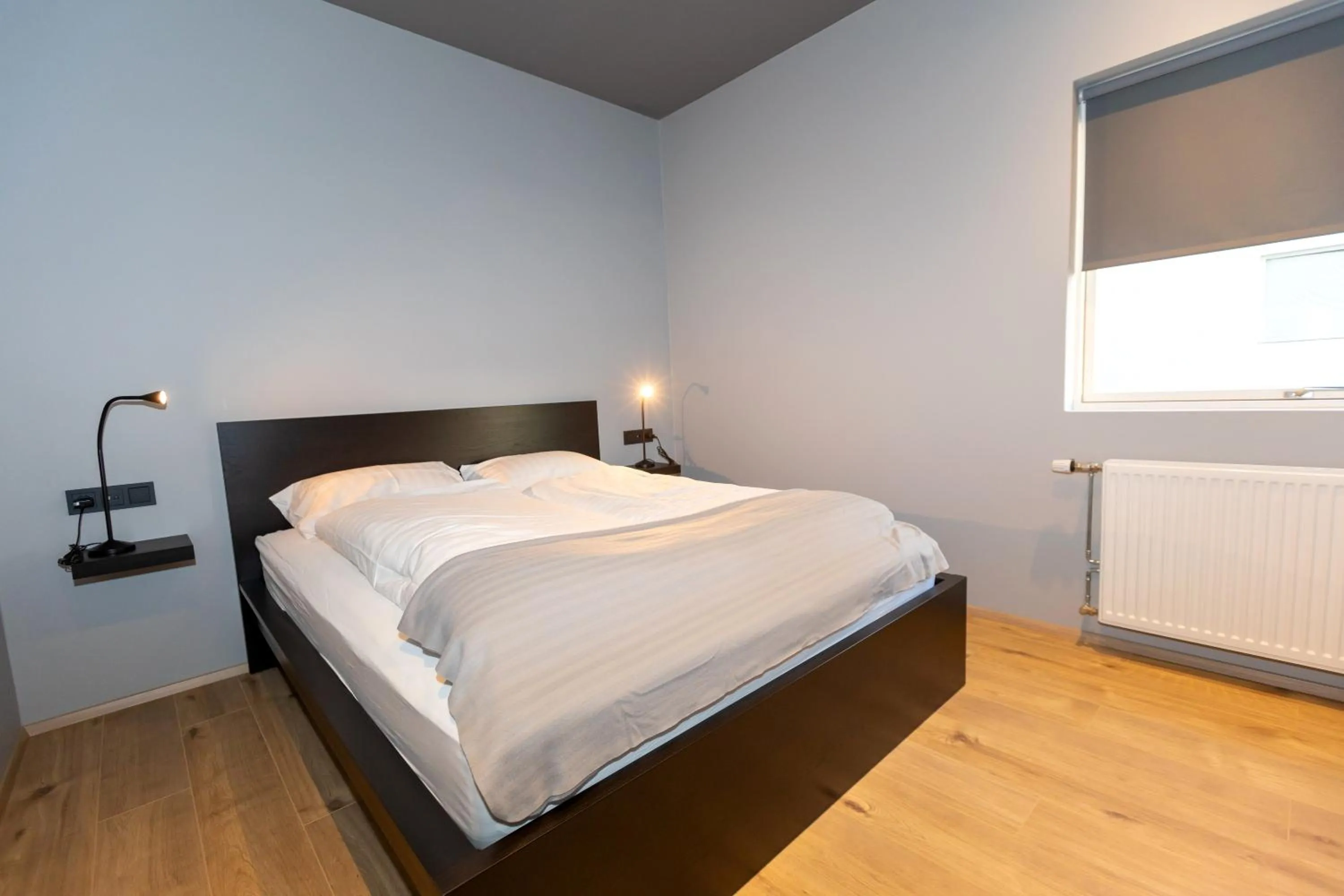 Bed in Akureyri Lux Apartments with hot tub access