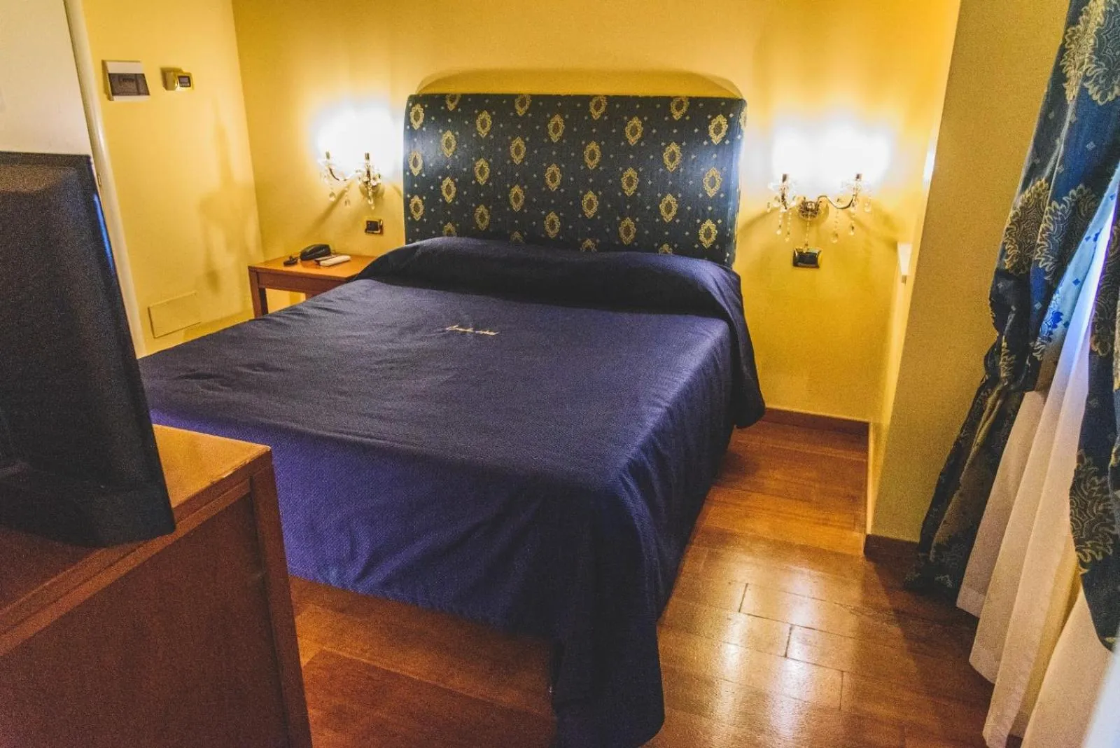 Bed in CANELLA HOTEL