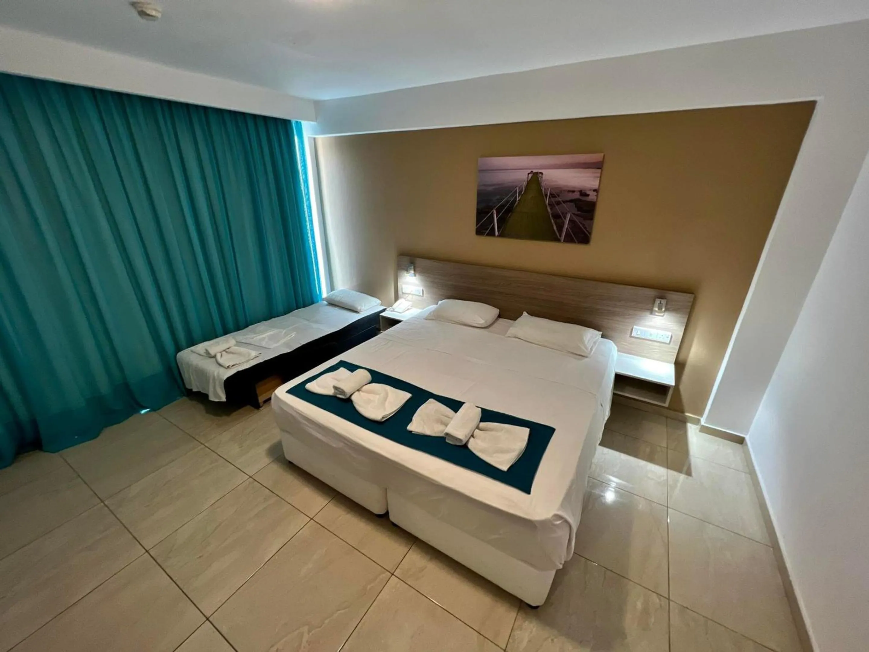 Bed in Sunny Blue Hotel