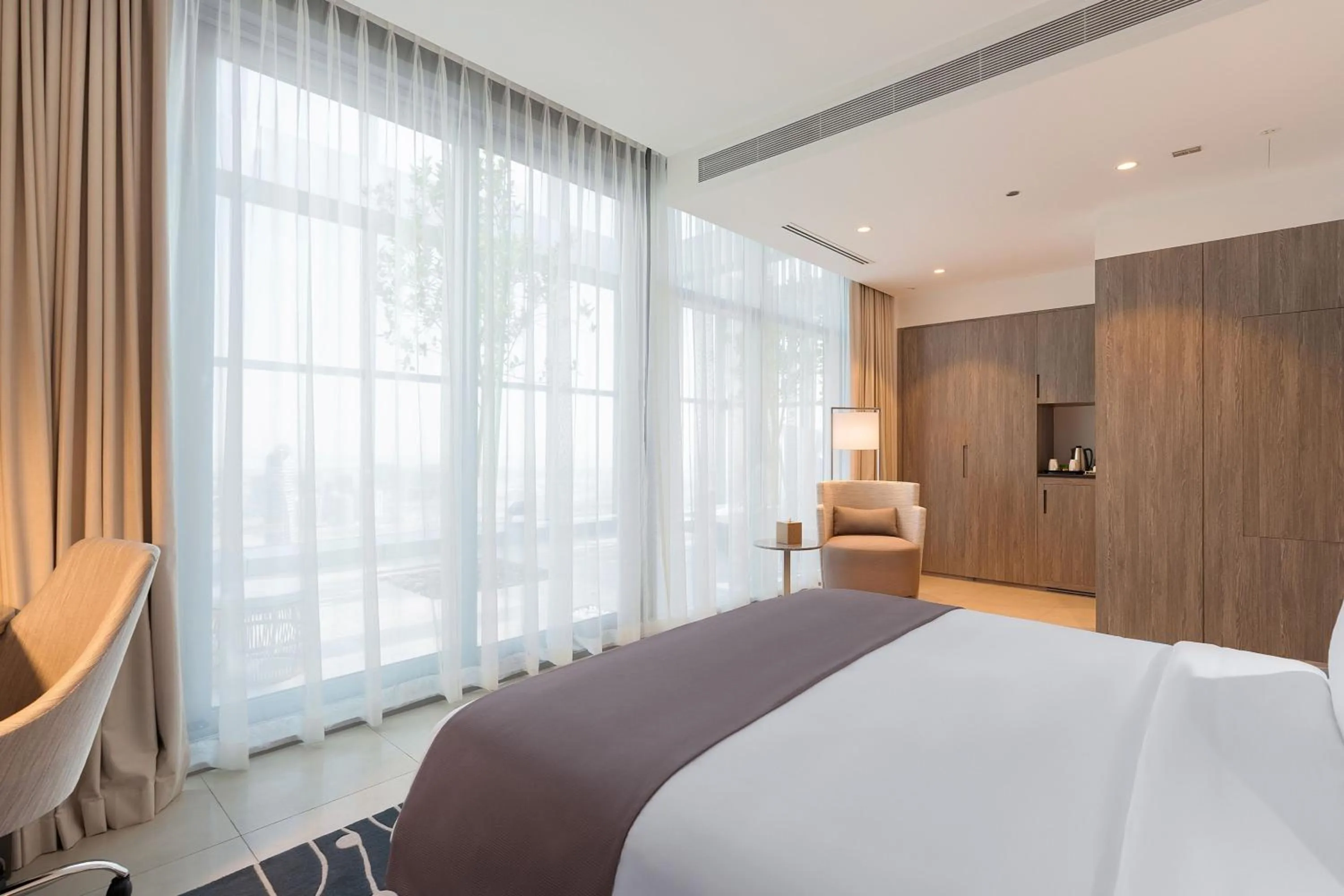 Swimming pool, Bed in The First Collection Dubai Jumeirah Village Circle, a Tribute Portfolio Hotel