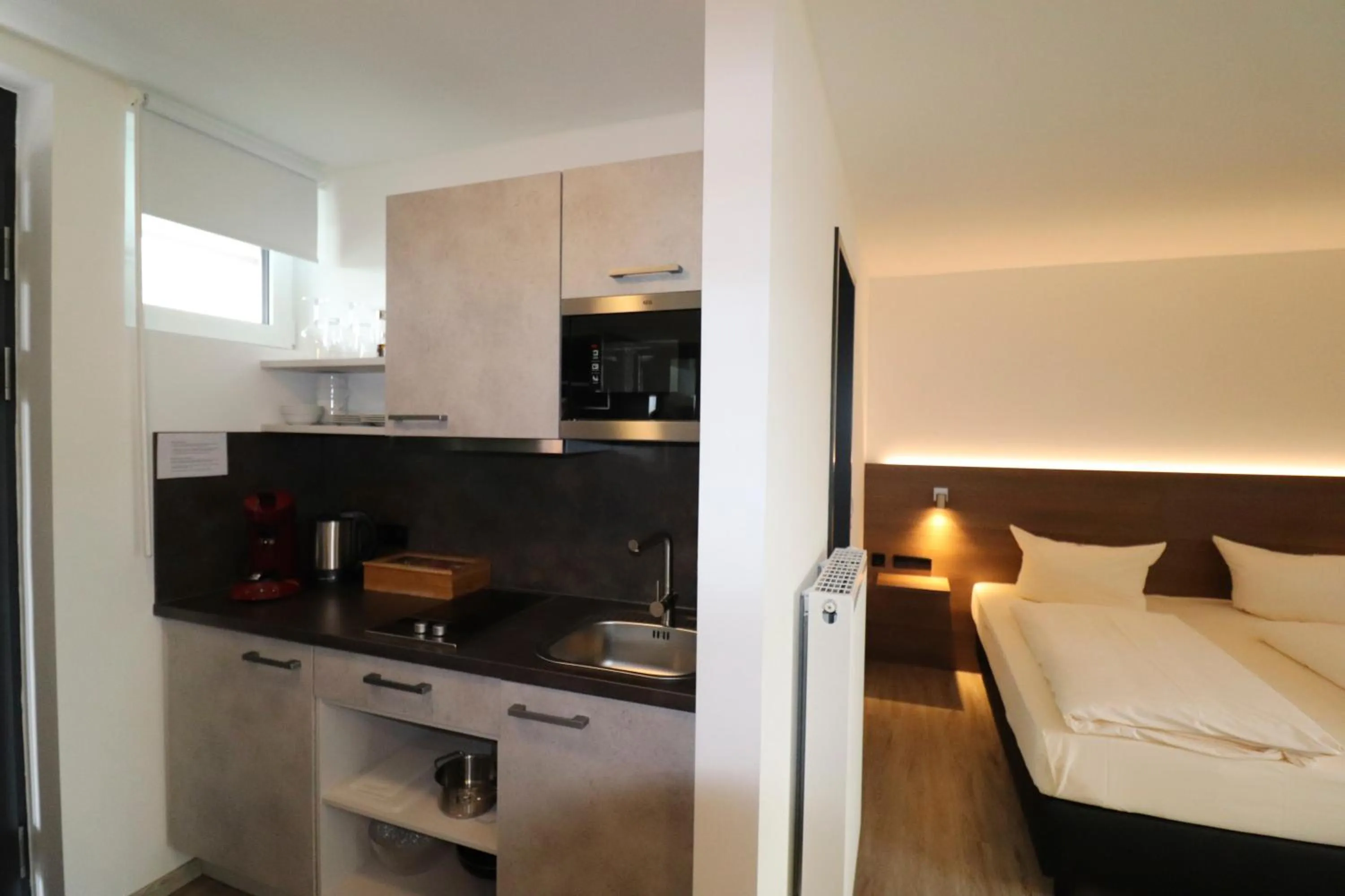 Kitchen or kitchenette, Bed in iQ-Hotel