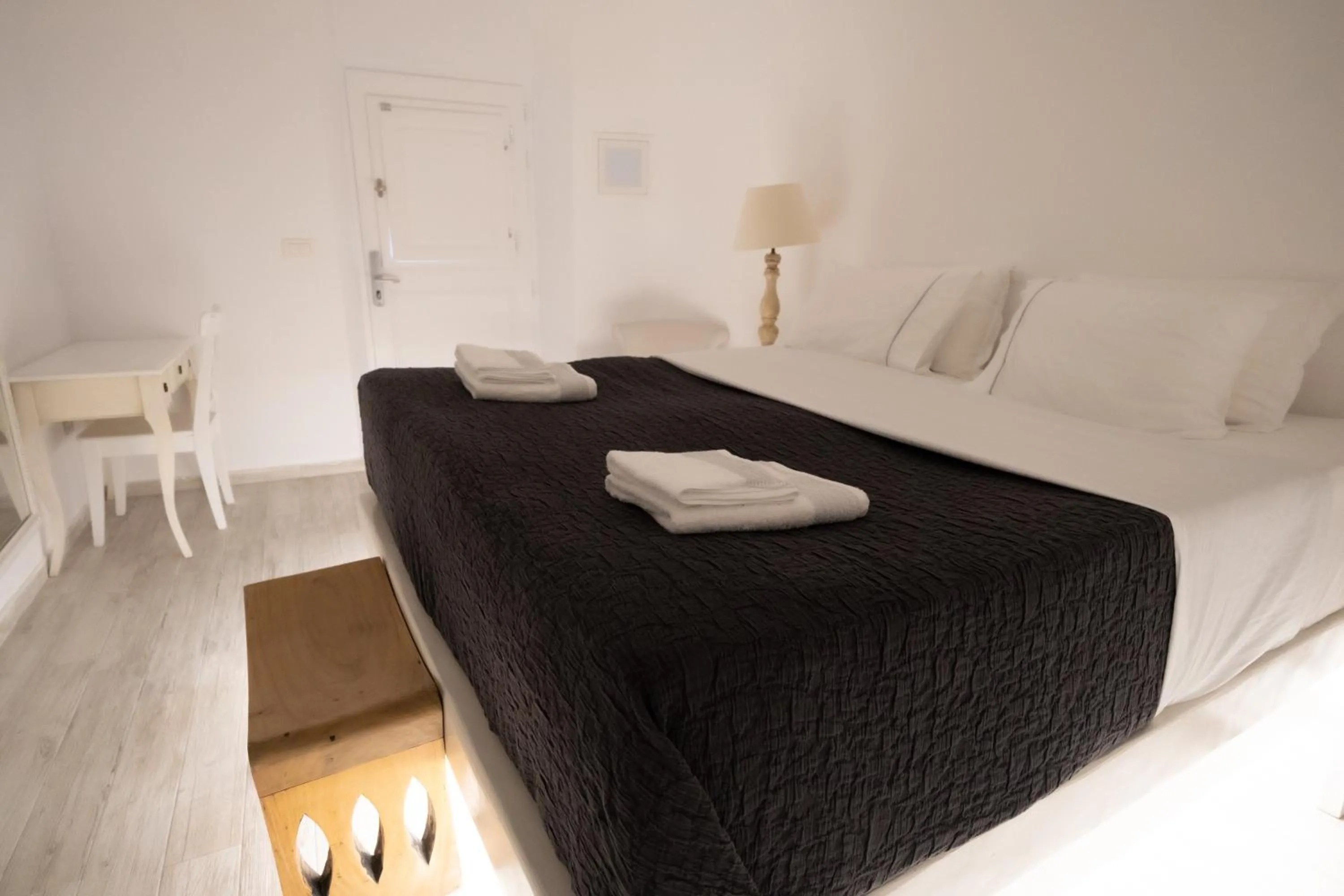 Bed in Anemos Cave Suites