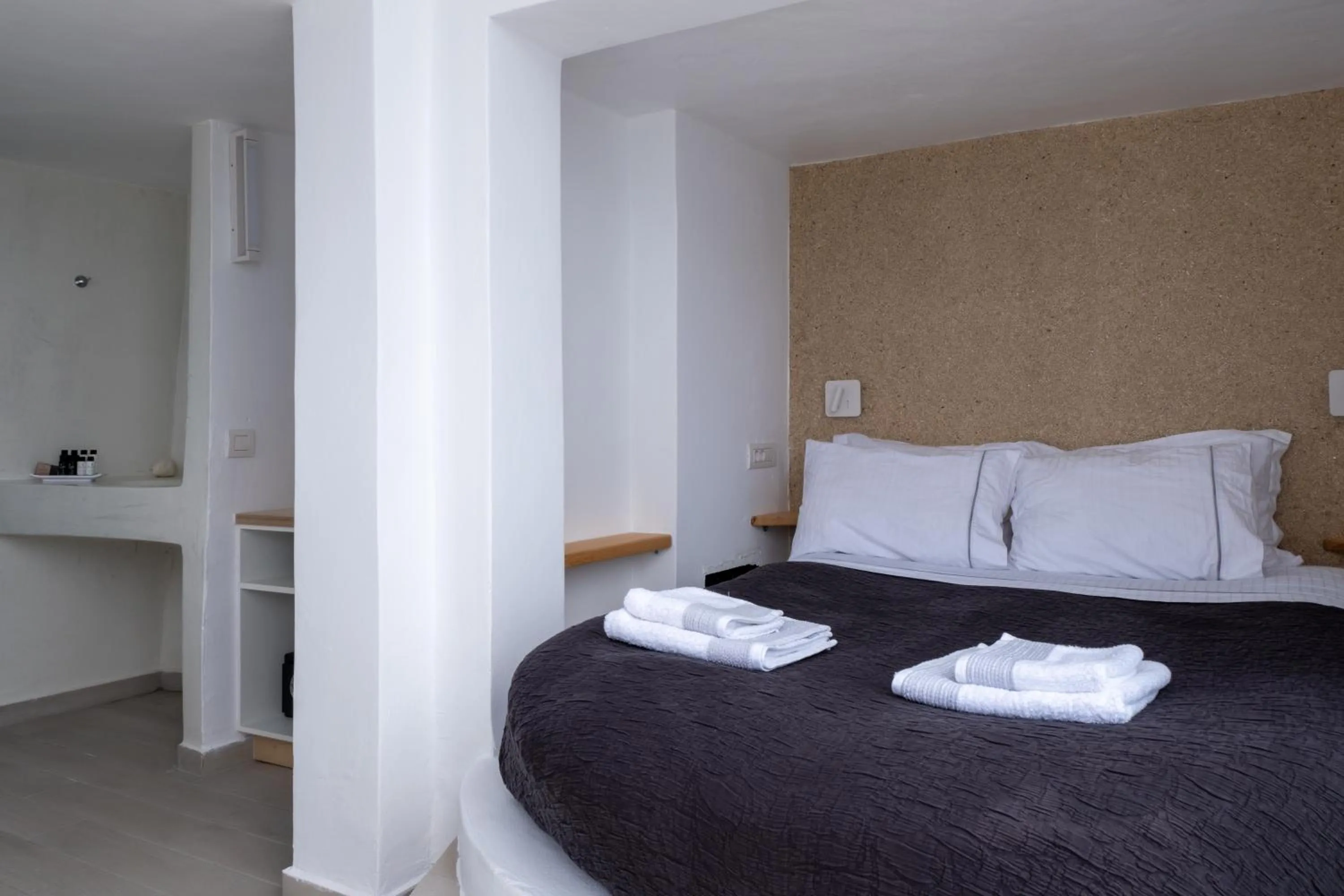 Bed in Anemos Cave Suites