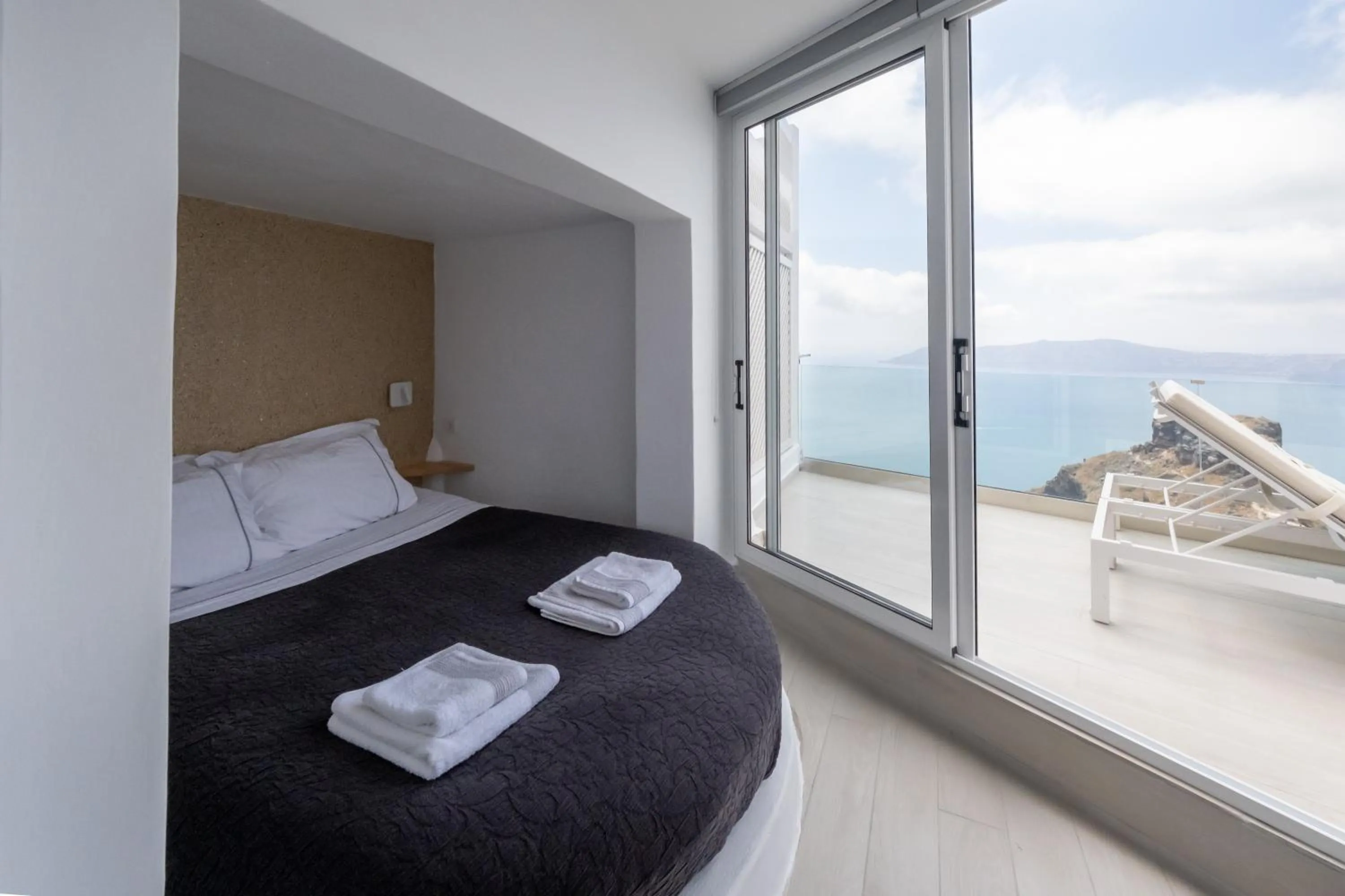 Bed in Anemos Cave Suites