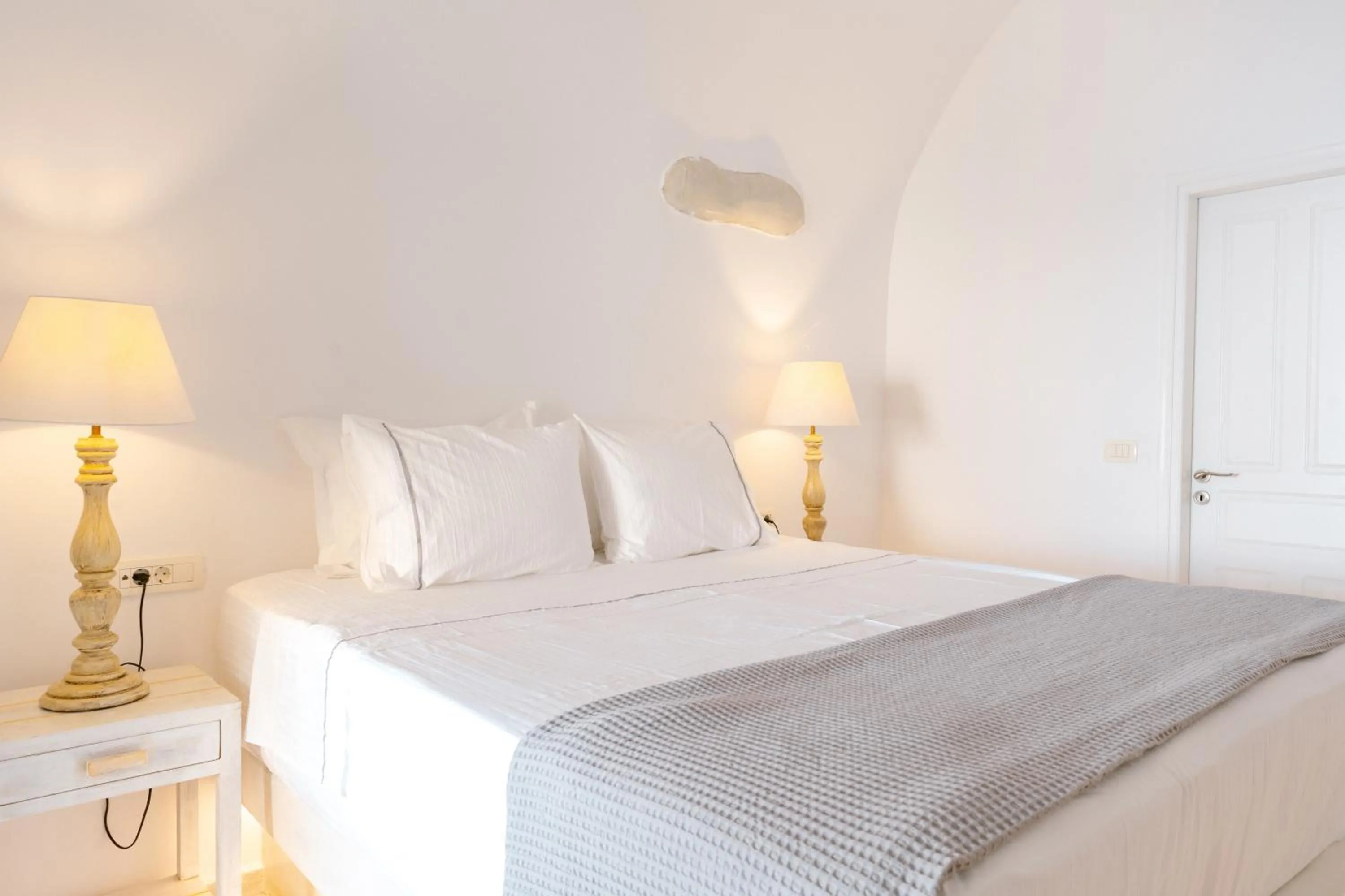 Bed in Anemos Cave Suites