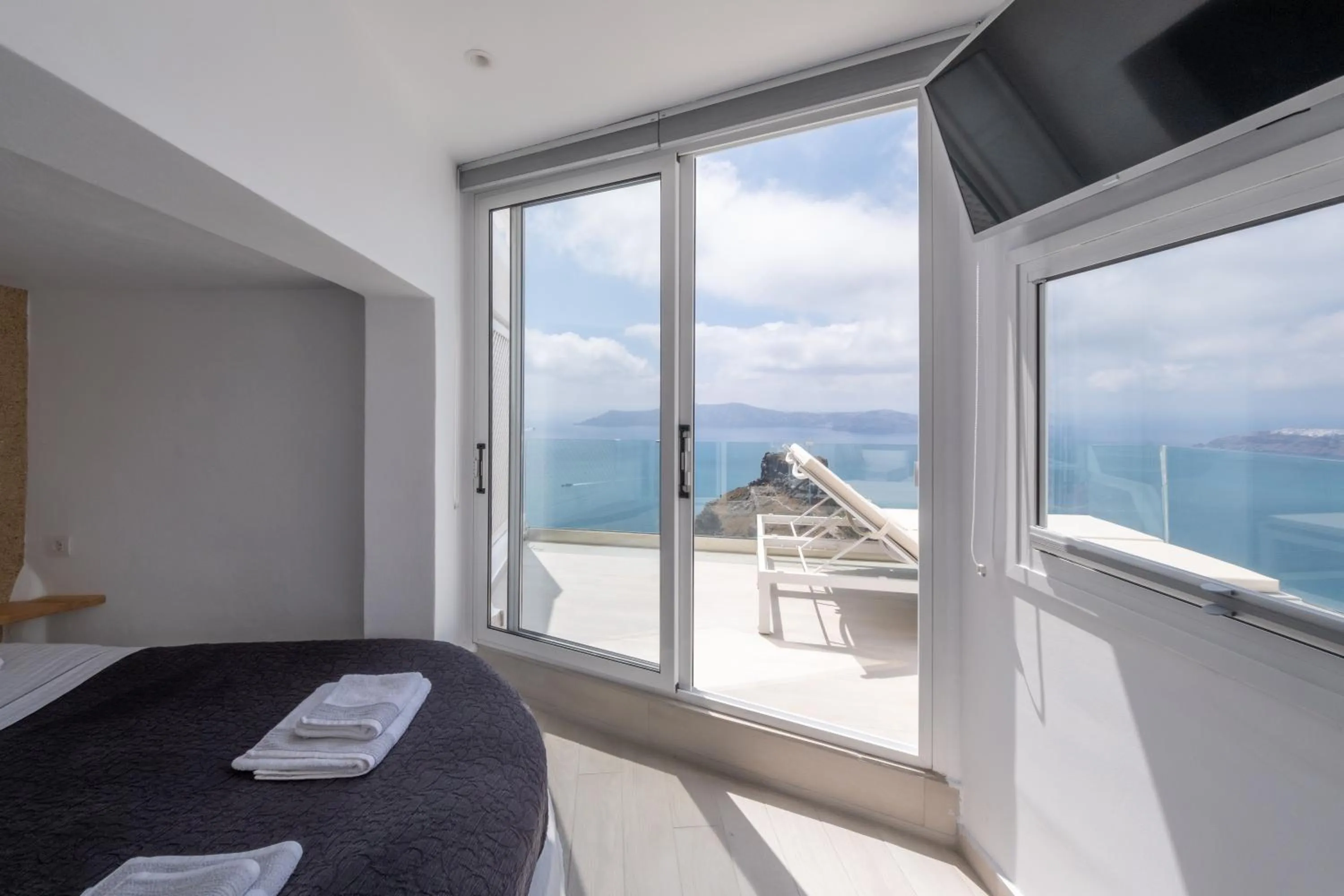 Bed in Anemos Cave Suites