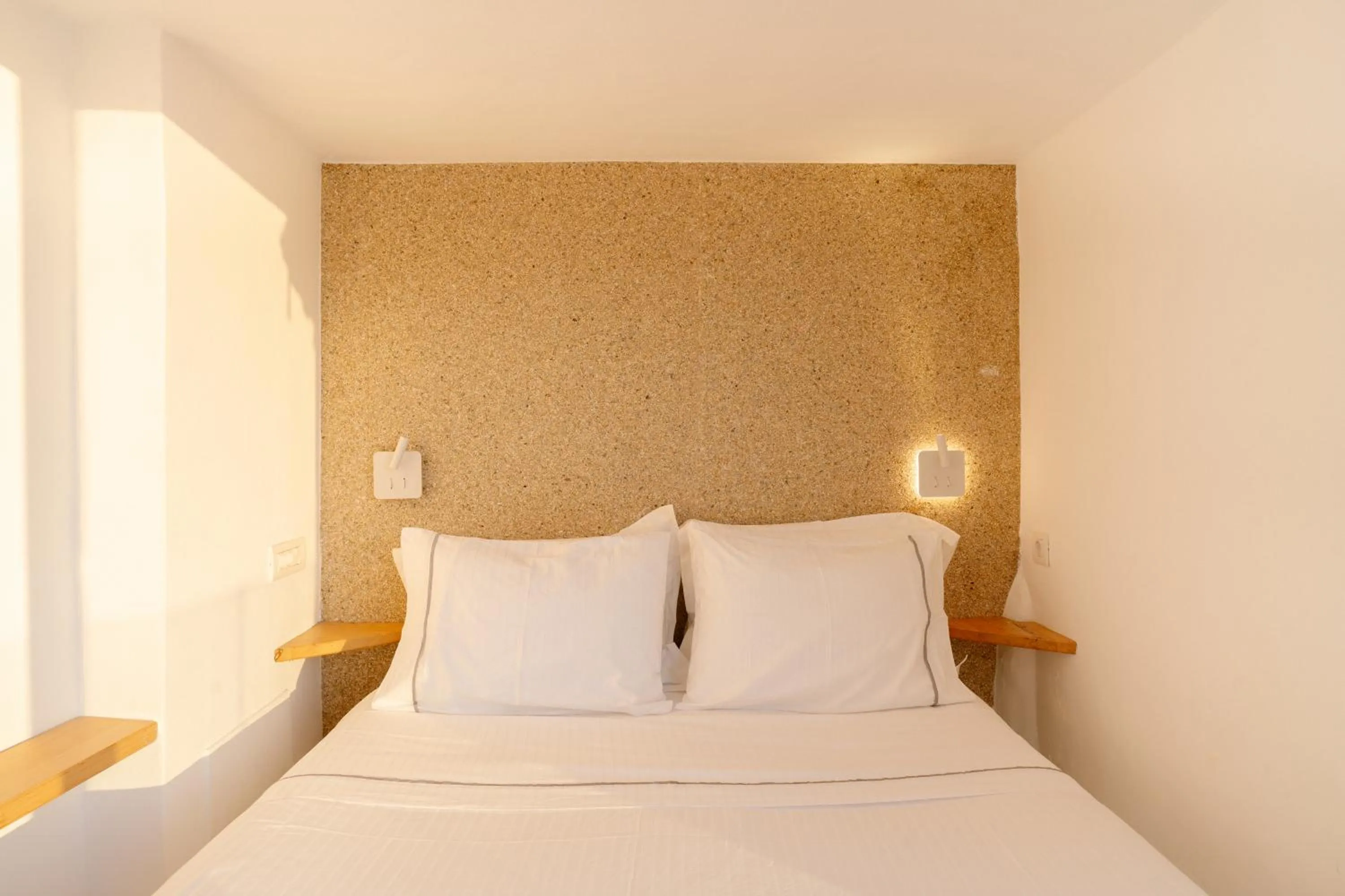 Bed in Anemos Cave Suites