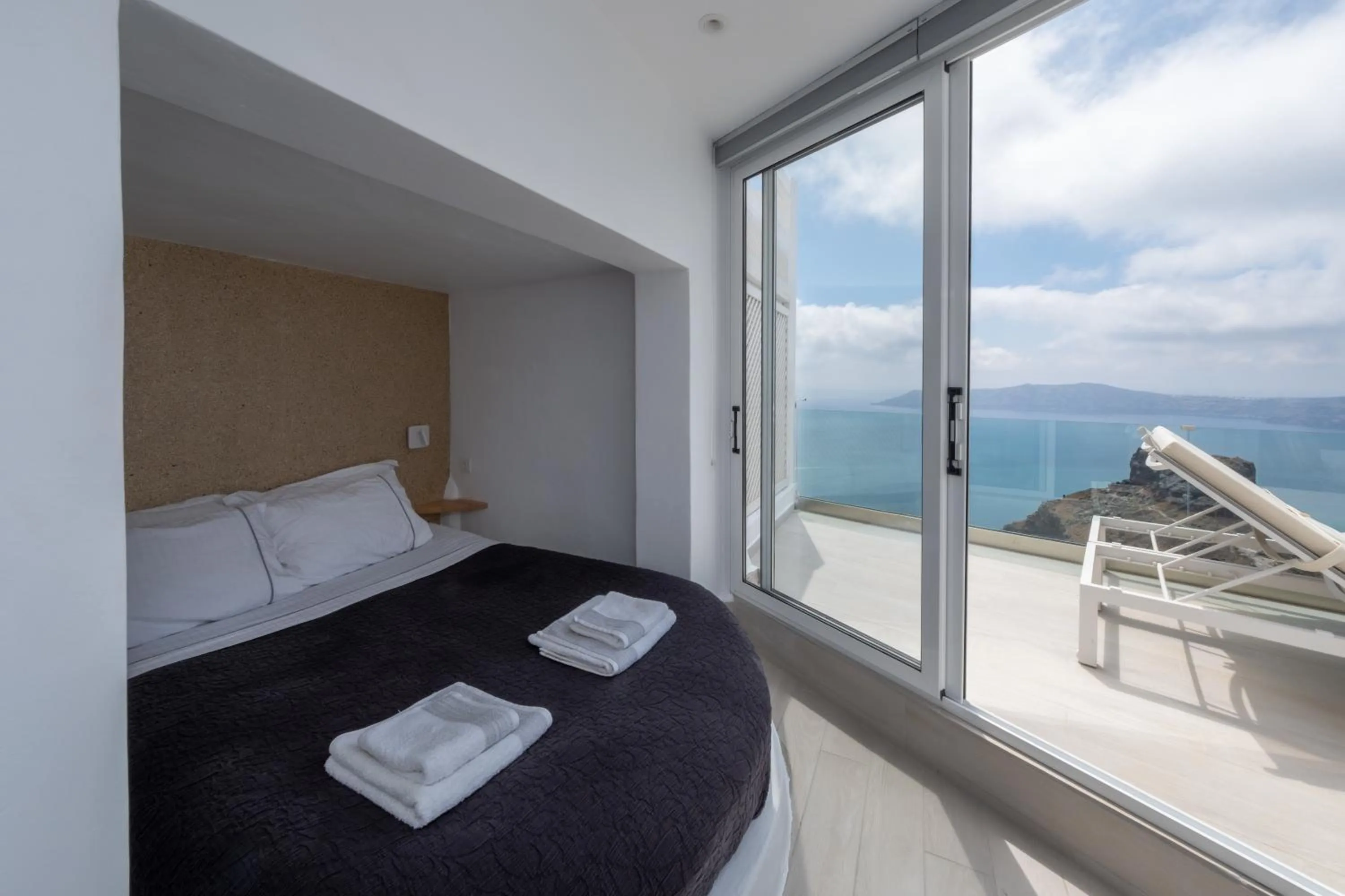 Bed in Anemos Cave Suites