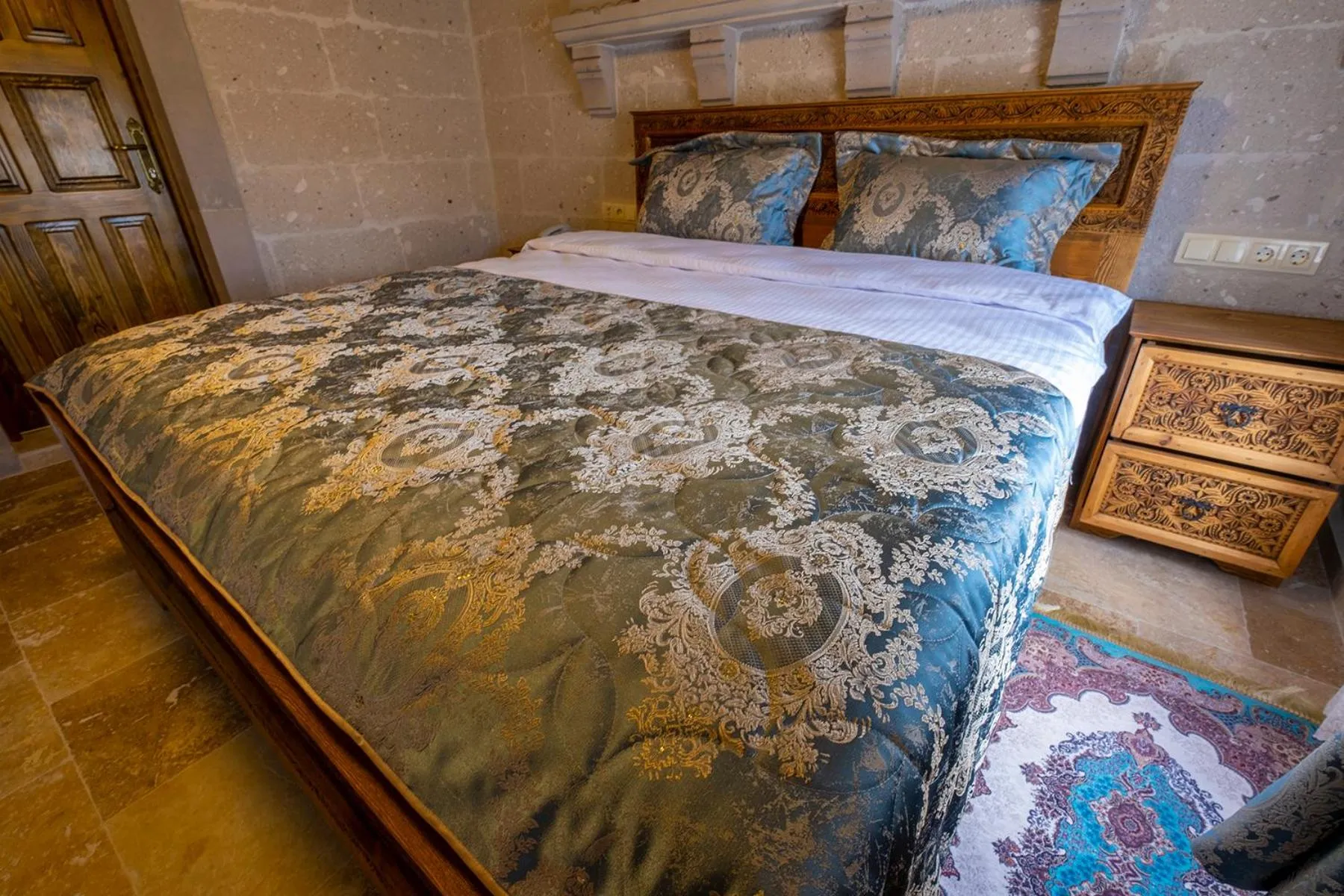 Bed in Underground Cave Suites Hotel