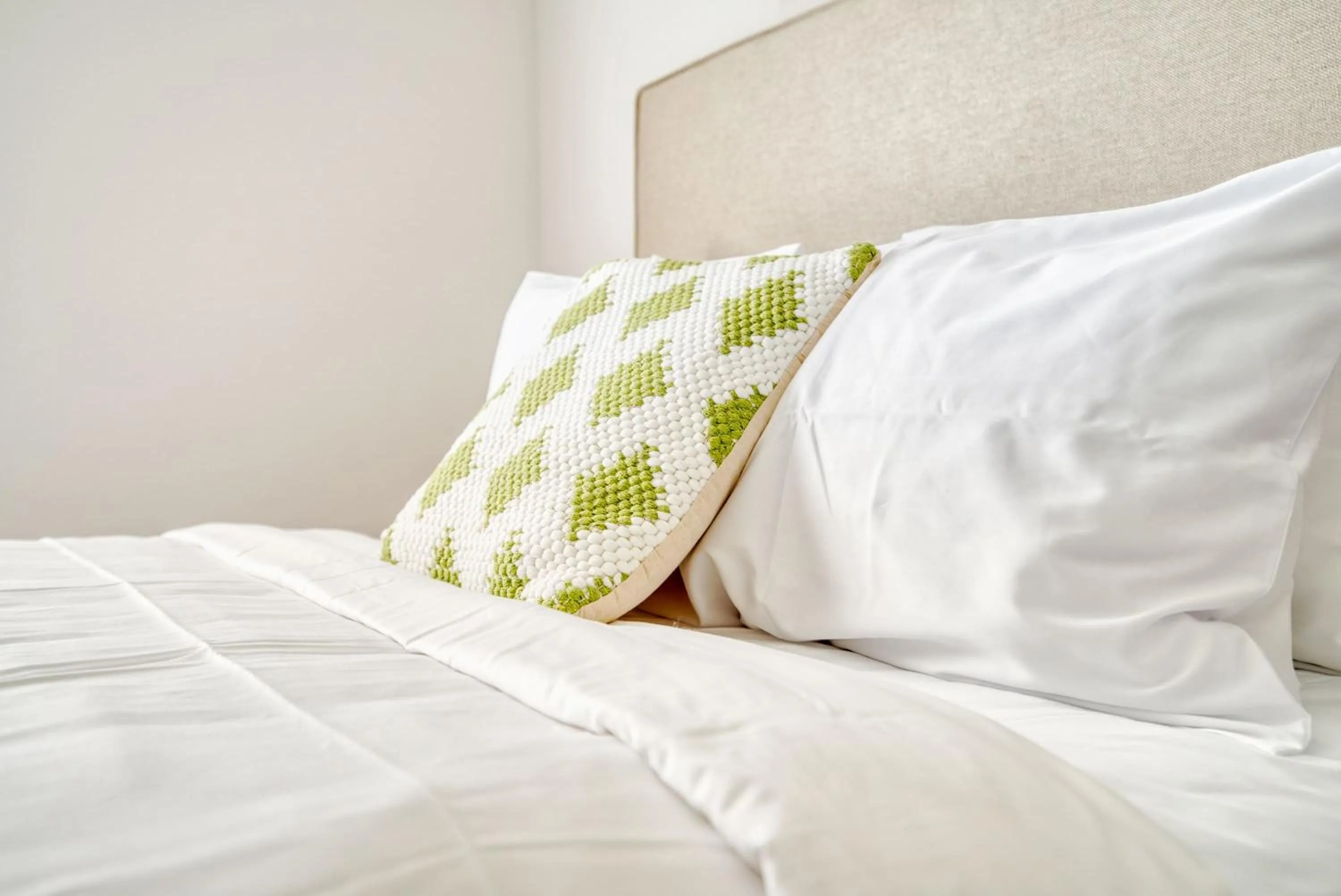 Bed in Luxe One Bedroom Apartment with Balcony