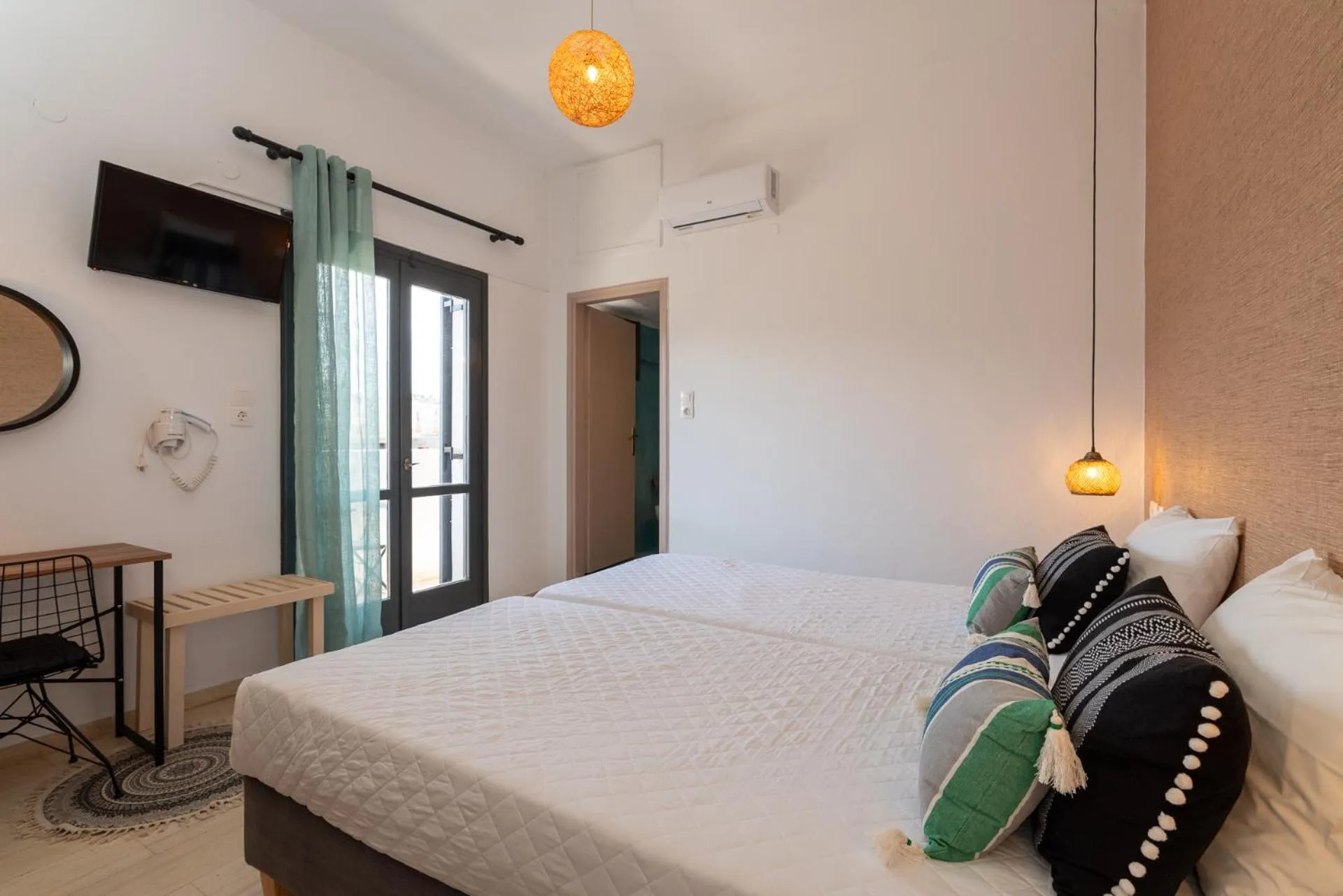 Bed in Anemos Inn by Estia