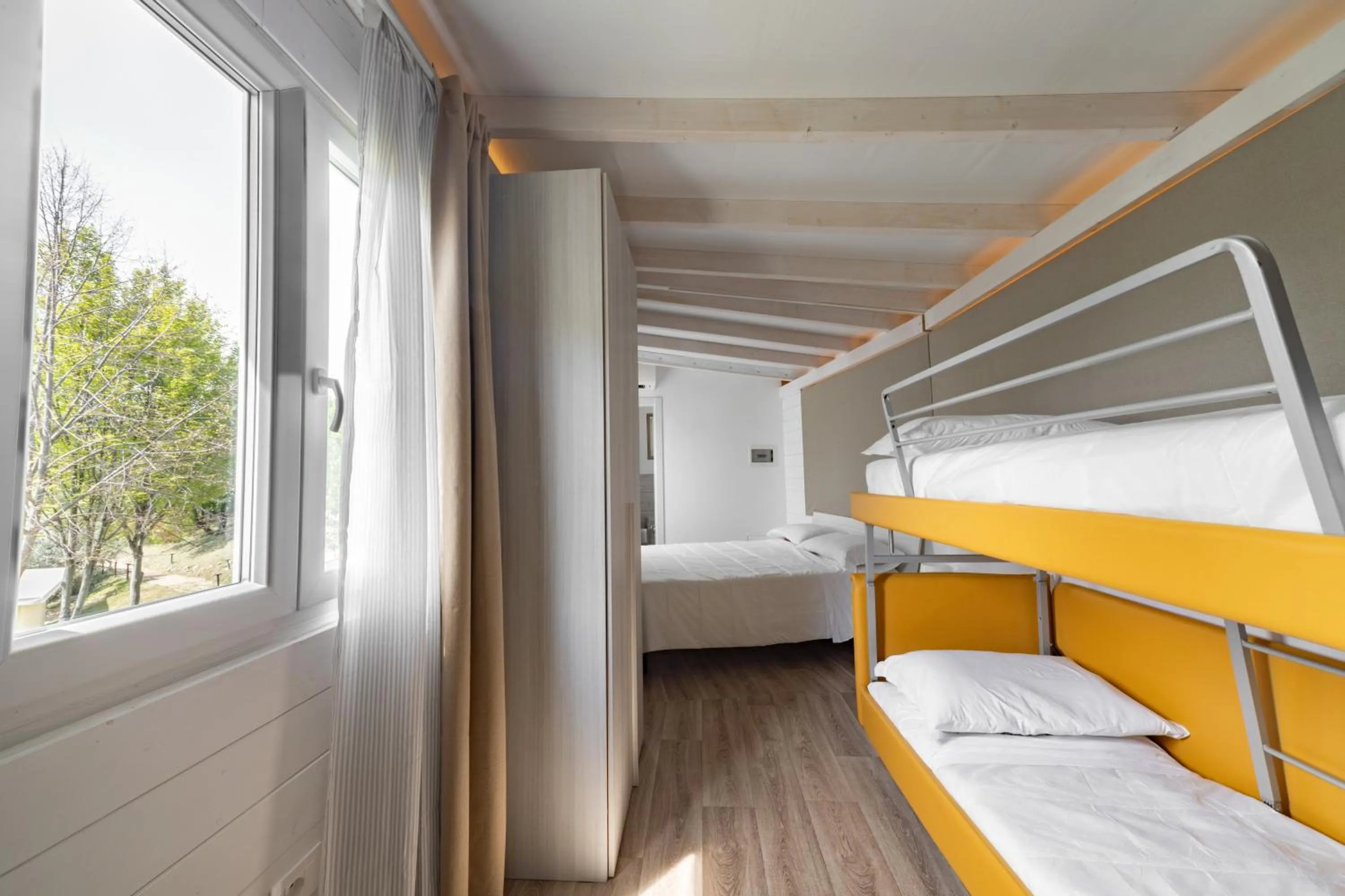 Bedroom, Bed in La Valle Dei Caprioli Village Bungalow Park - Freelandia Azienda Agricola