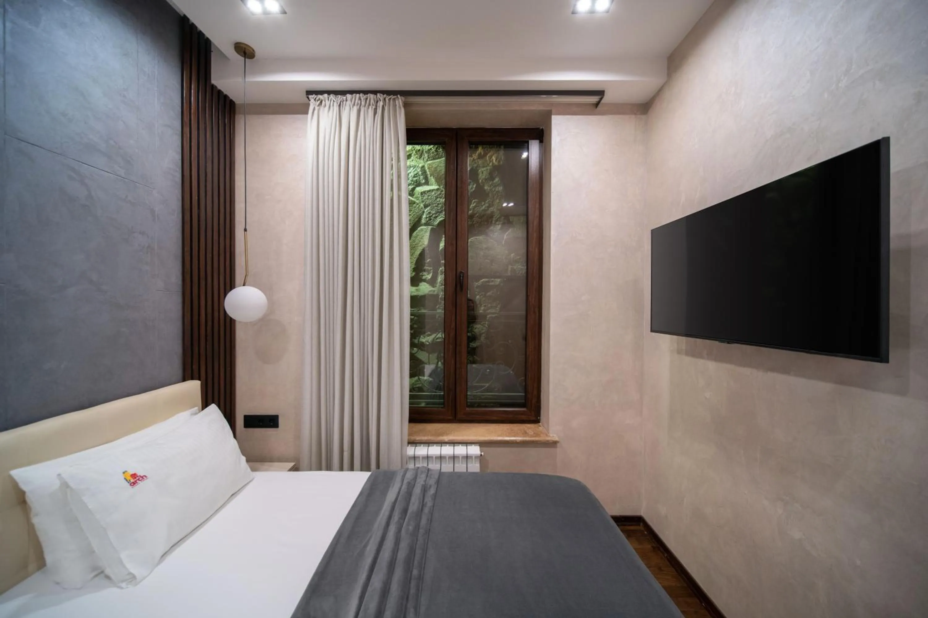 Bed in Arch Apart Hotel