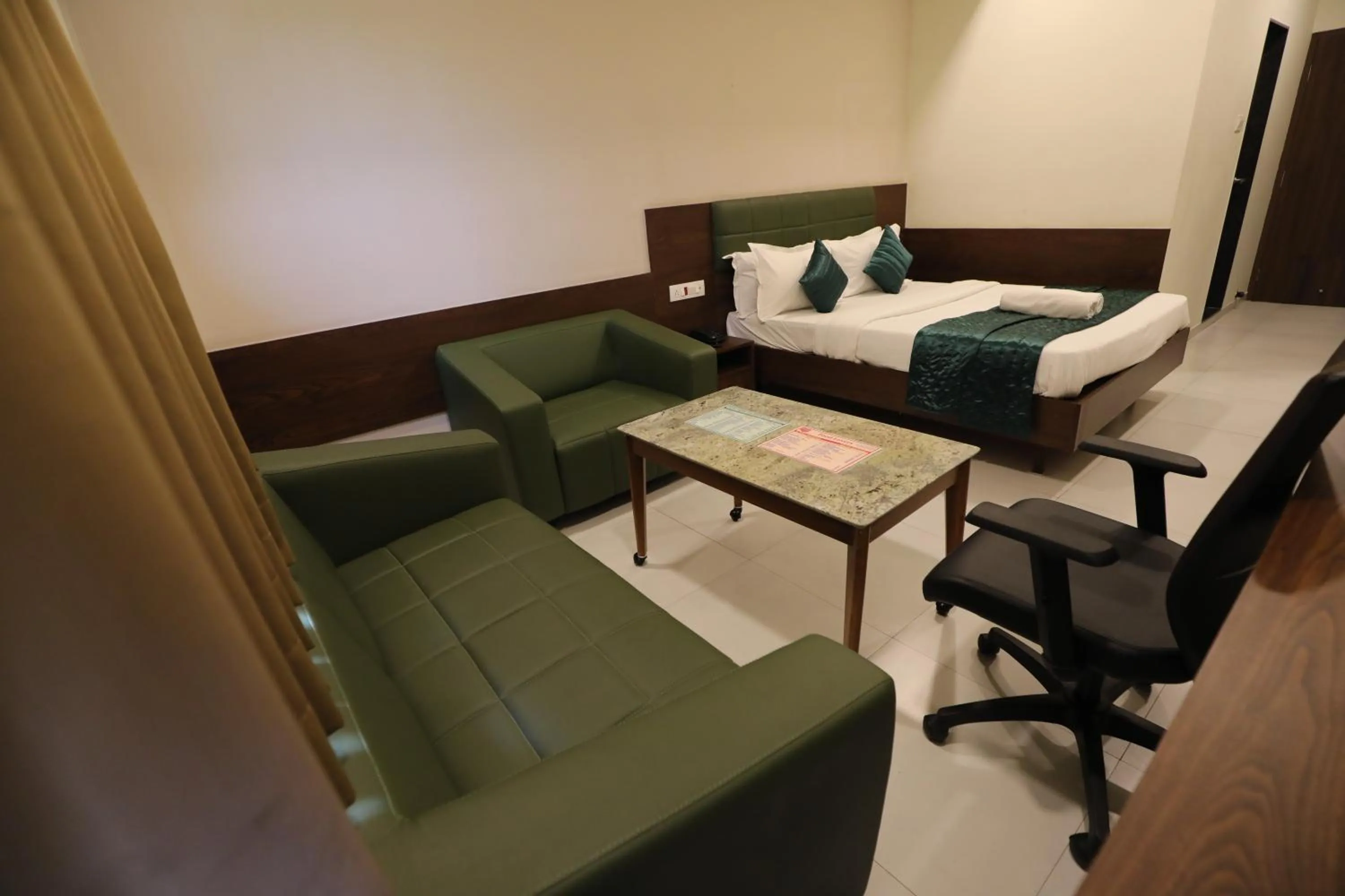 Bed in Greenotel Rooms Hazira, Surat