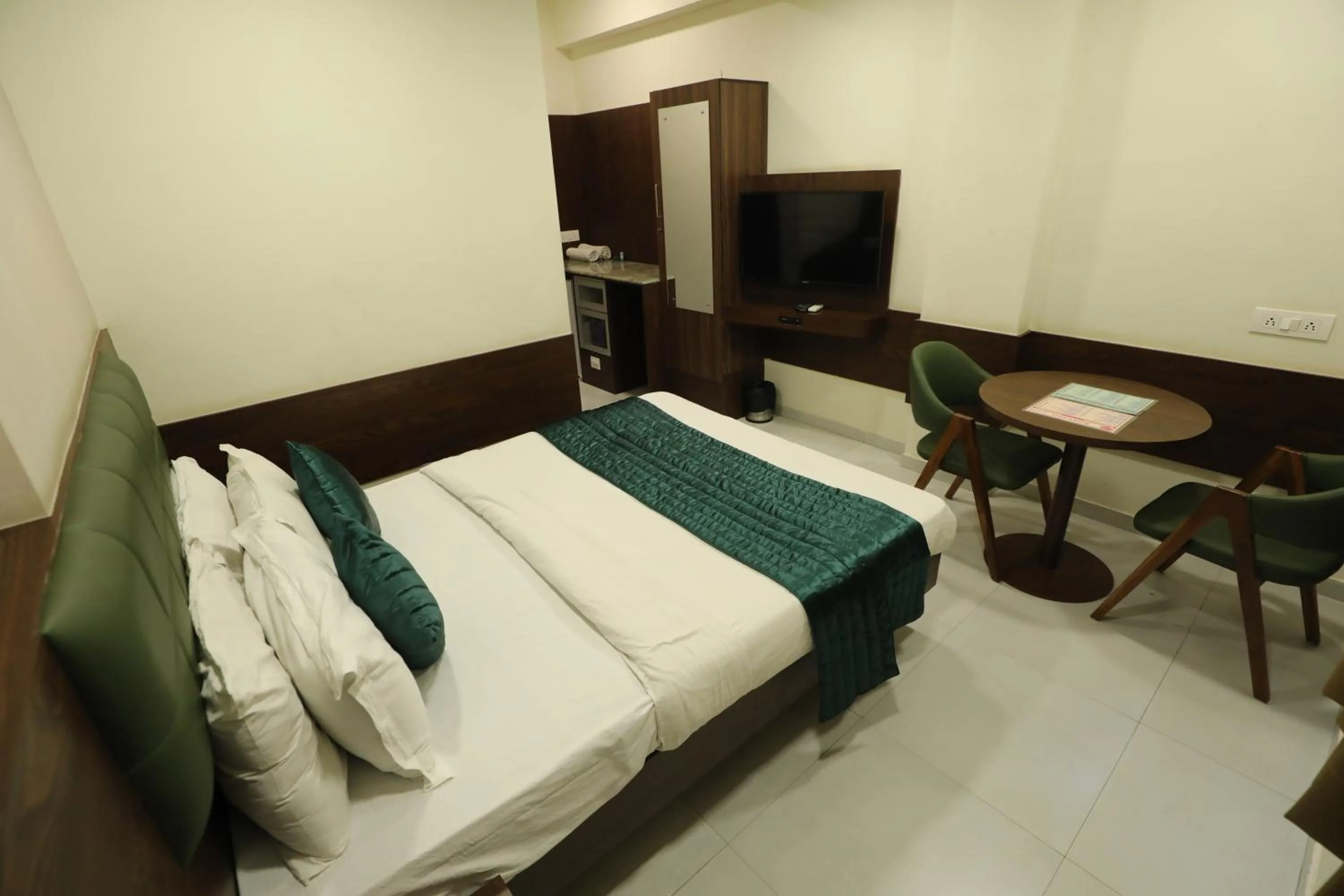 Bed in Greenotel Rooms Hazira, Surat