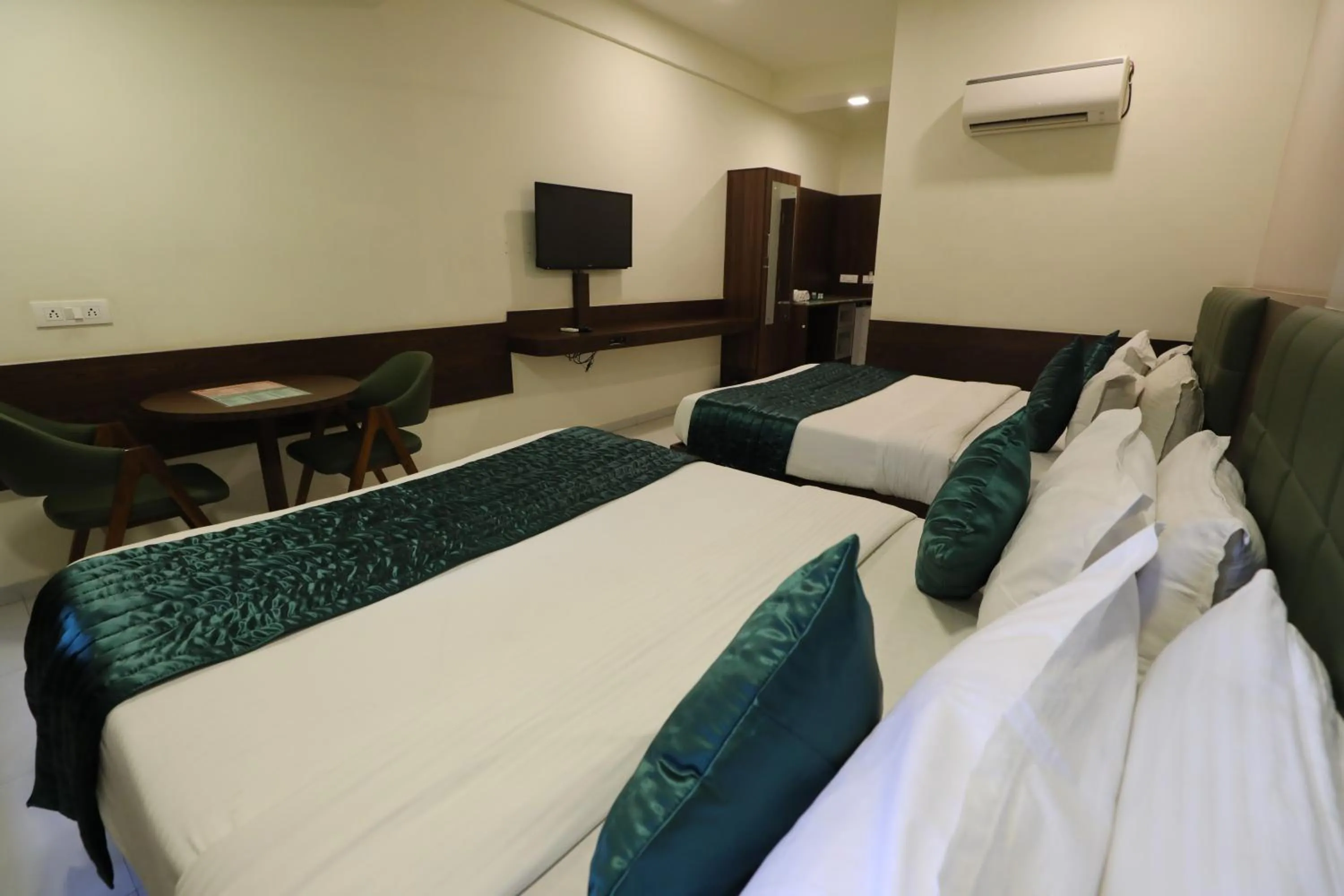Bed in Greenotel Rooms Hazira, Surat