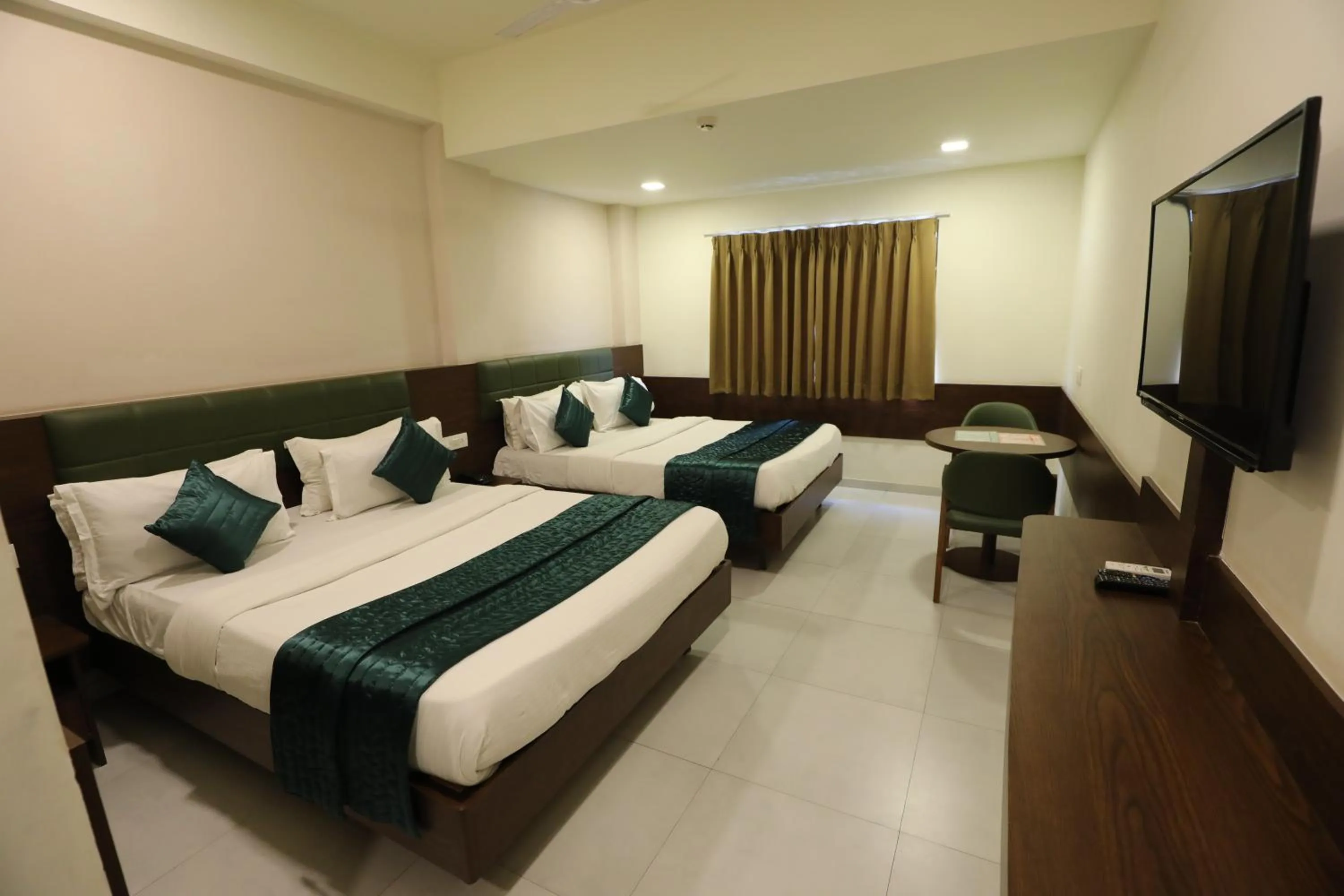 Communal lounge/ TV room, Bed in Greenotel Rooms Hazira, Surat